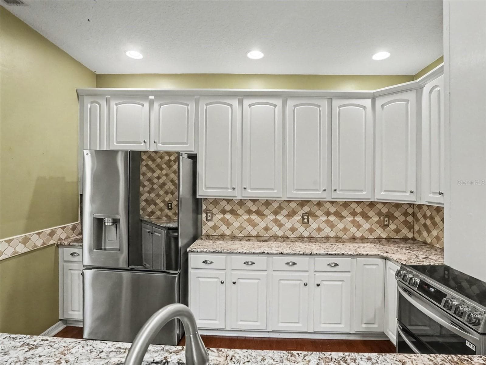 Kitchen with a new refrigerator purchased in October 2025 - 190 HARBOUR COVE WAY, CLERMONT