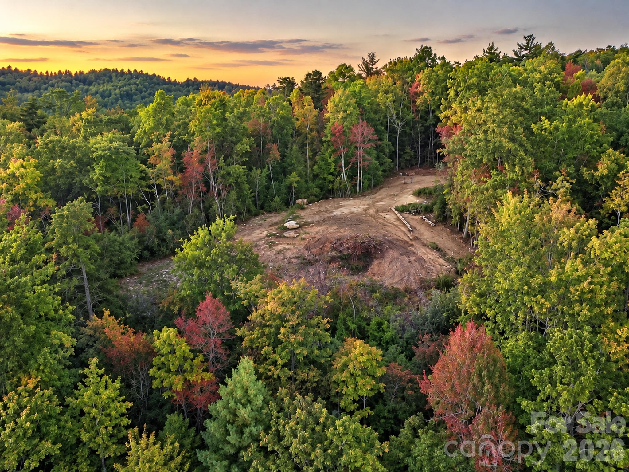 Aerial view of the cleared mountainside homesite surrounded by mature trees. - 000 Bulling Creek Road, Penrose