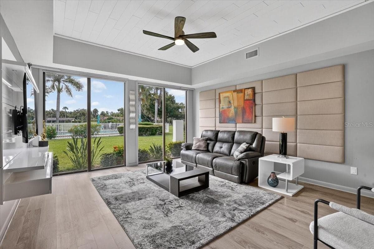 living room with sliding glass doors - 2319 LAKESIDE MEWS #B3, SARASOTA