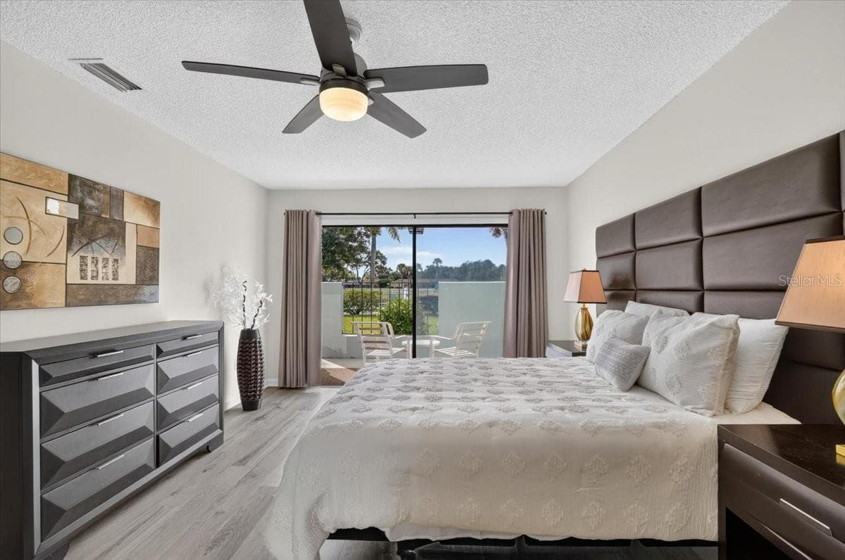 master bedroom with sliders to the patio - 2319 LAKESIDE MEWS #B3, SARASOTA