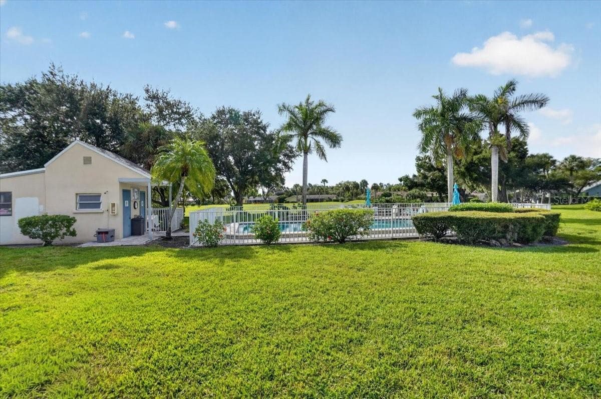 pool view from the living room - 2319 LAKESIDE MEWS #B3, SARASOTA