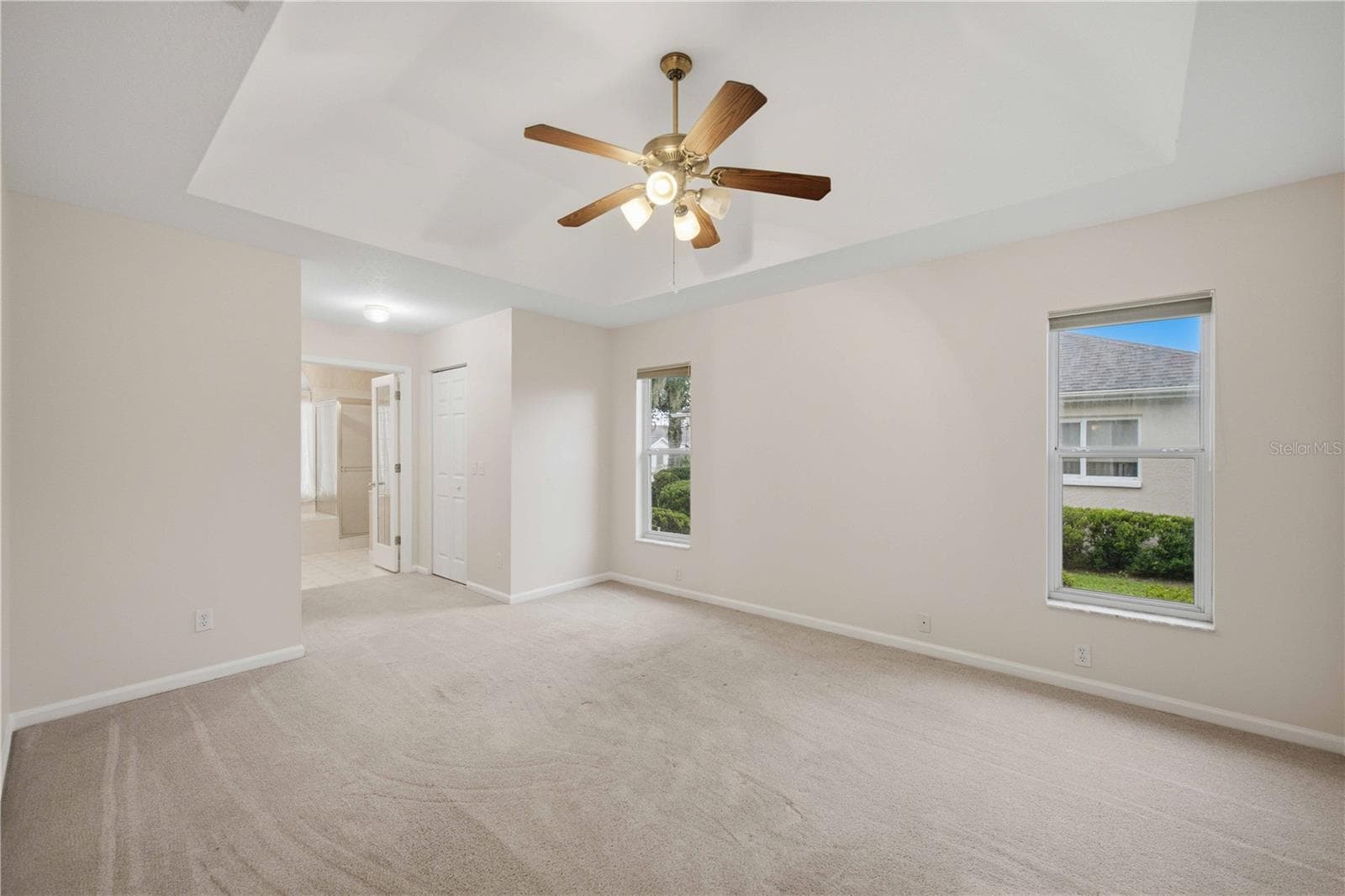 Primary bedroom with tray ceiling - 5126 NW 21ST LOOP, OCALA