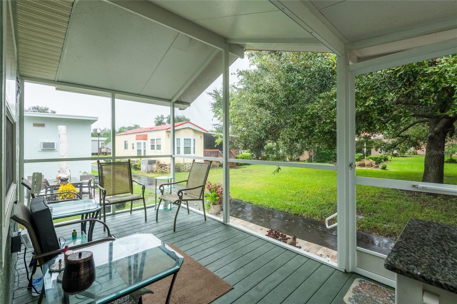 You just can't beat the view. Custom designed steps and pavers keep the rain water away from the home. That is the sidewalk - not water. - 6544 LA MESA RD, LAND O LAKES