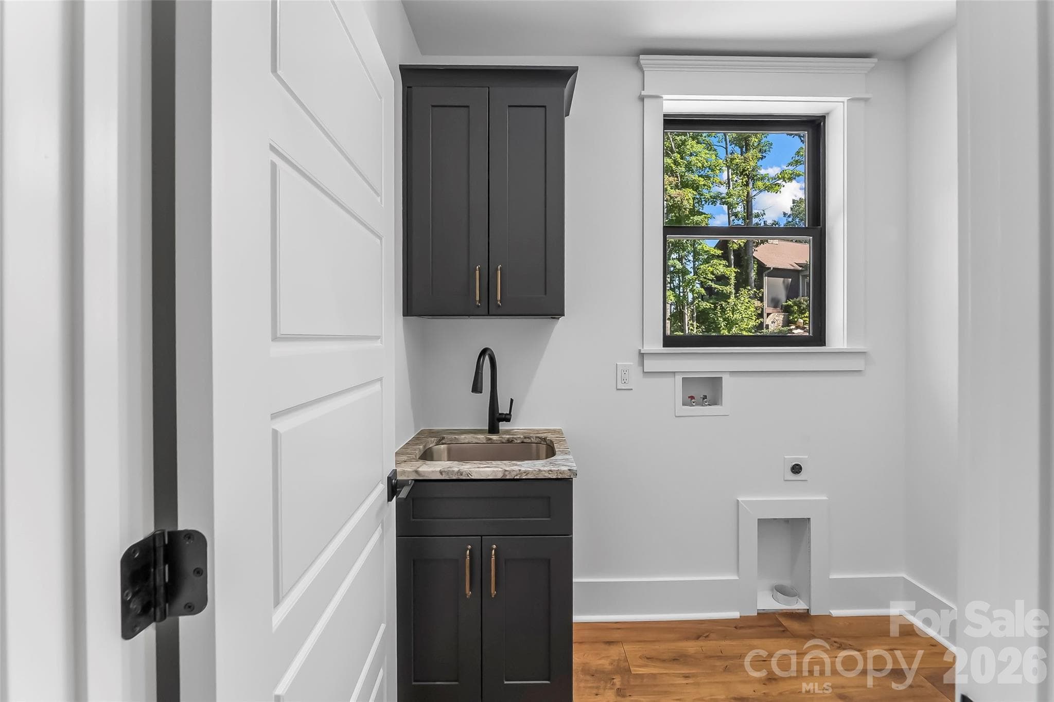 Main level laundry room with utility sink - 4898 Soaring Top Lane, Lenoir