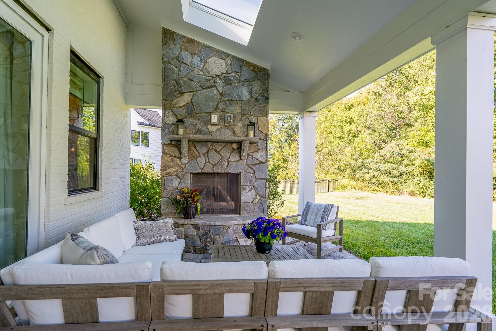 Gorgeous Stonek outdoor Fireplace with bright Sky Lights overhead - 9588 Pacing Lane NW, Concord
