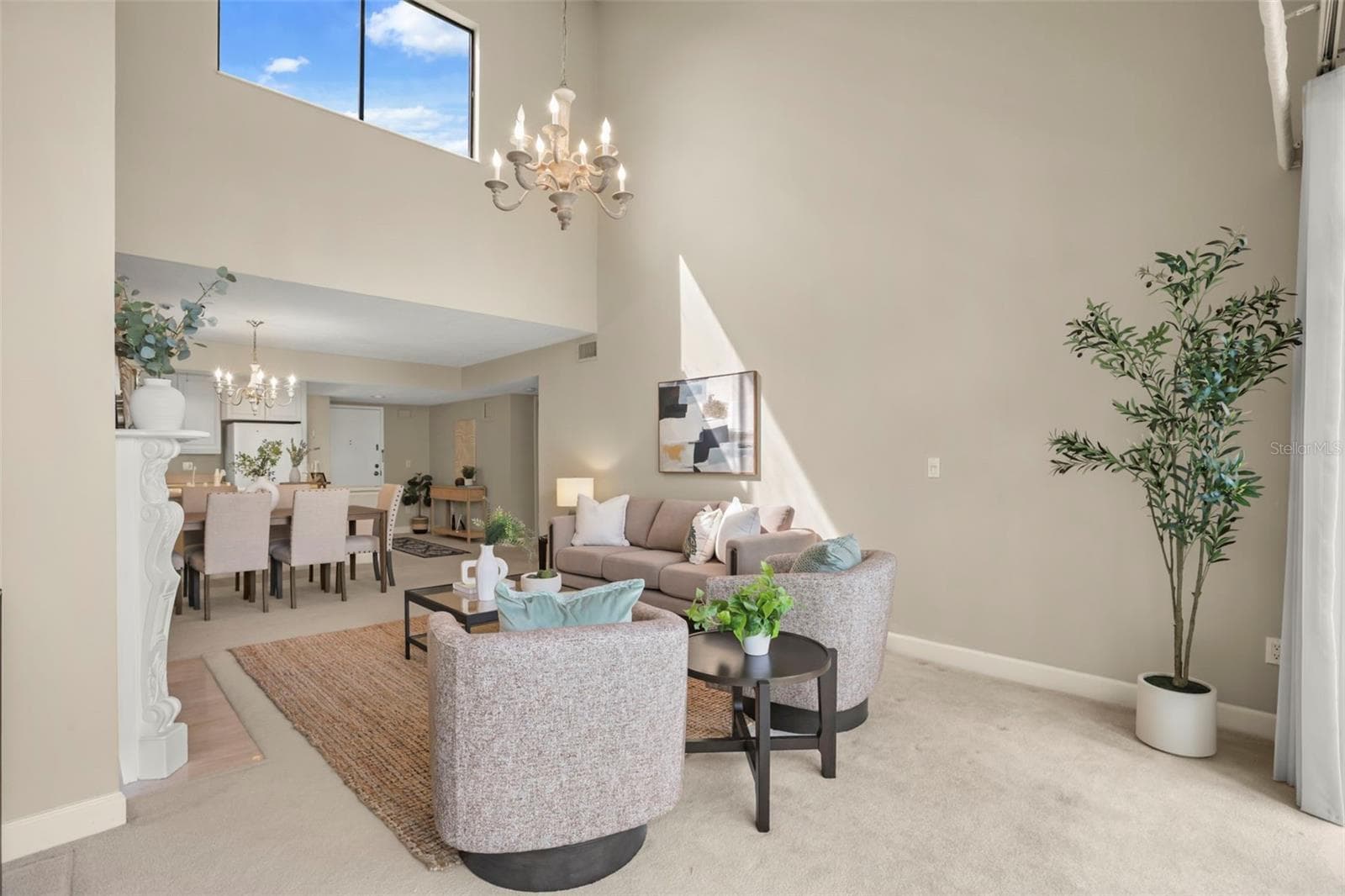 The top-floor location means natural light fills the large living room with additional windows along the vaulted ceiling! - 300 CAROLINA AVE #402C, WINTER PARK