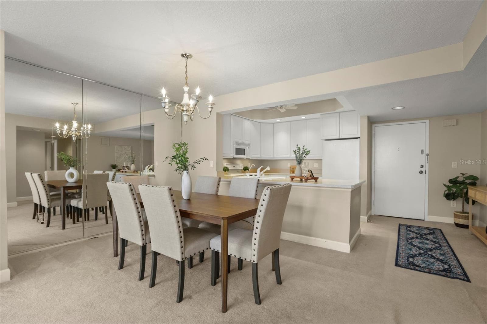 The dining room and large foyer frame the kitchen. - 300 CAROLINA AVE #402C, WINTER PARK