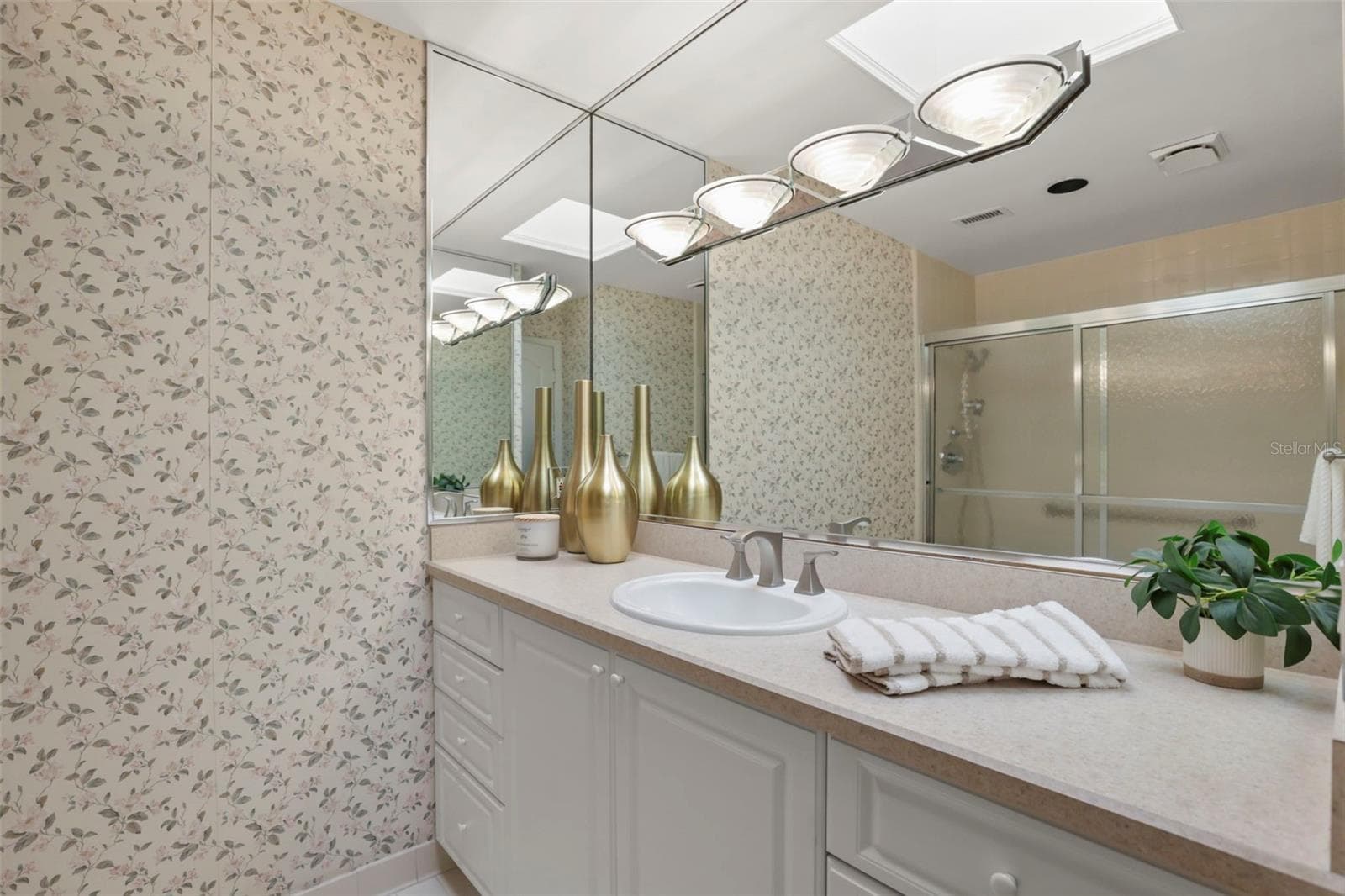 The primary bathroom offers abundant storage in a large vanity area and a full linen closet. - 300 CAROLINA AVE #402C, WINTER PARK