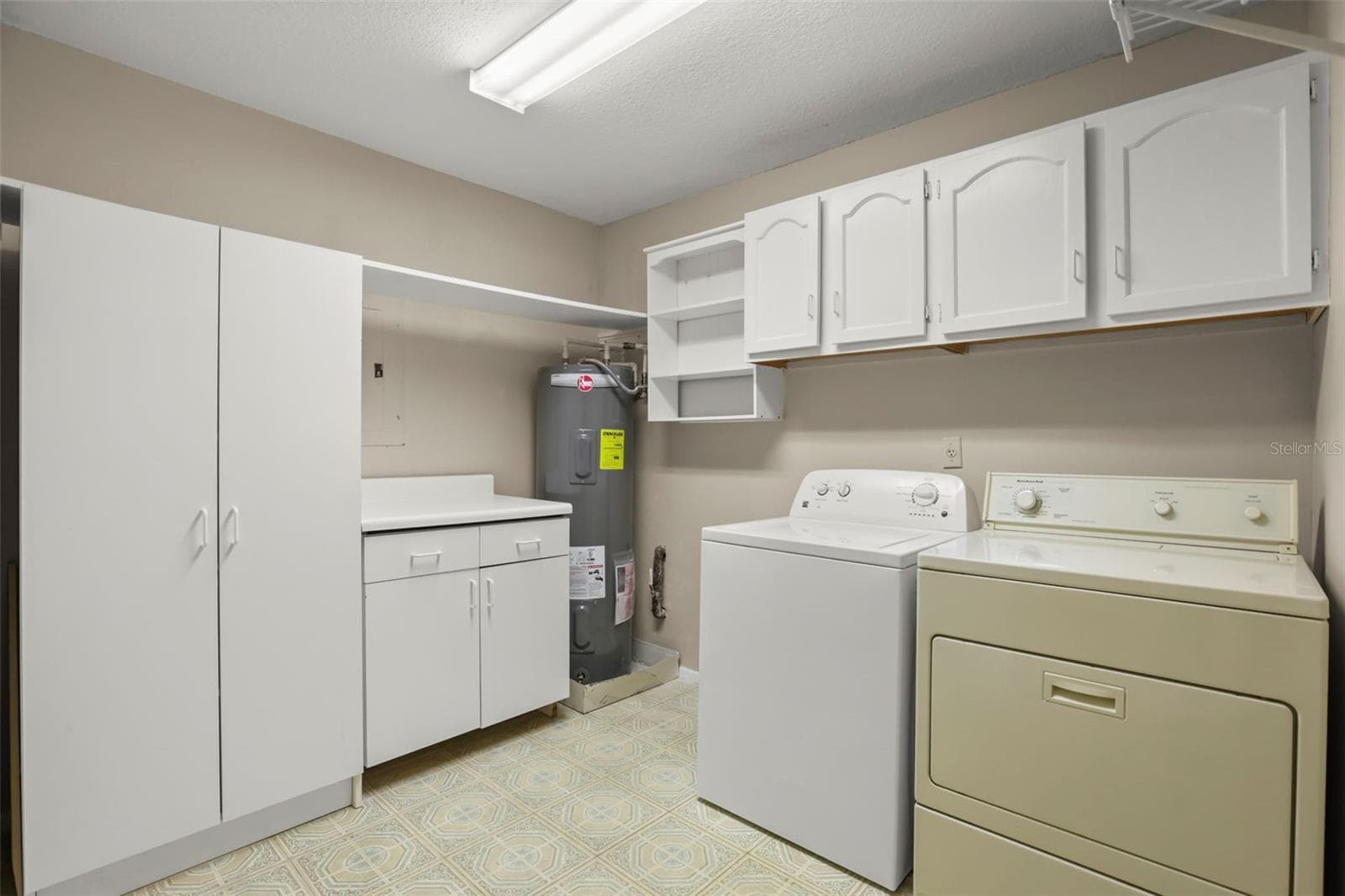 This condo boasts an IN UNIT laundry room with phenomenal storage above the washer and dryer and additional cabinets and counter space adjacent. - 300 CAROLINA AVE #402C, WINTER PARK
