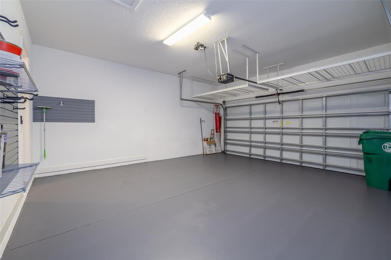 2 car garage w storage racks - 1076 GARDENSHIRE LN, DELAND