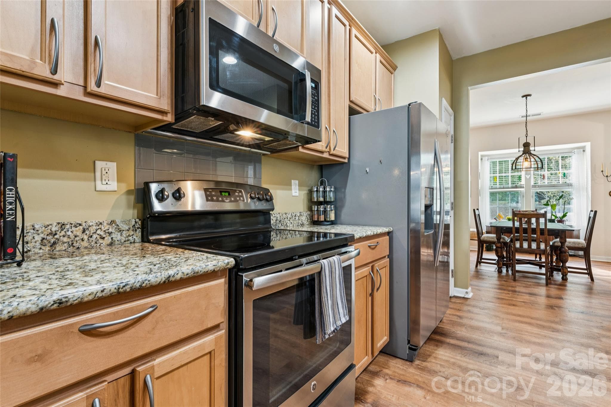 Galley-style kitchen with granite countertops - 9506 Birkwood Court, Charlotte