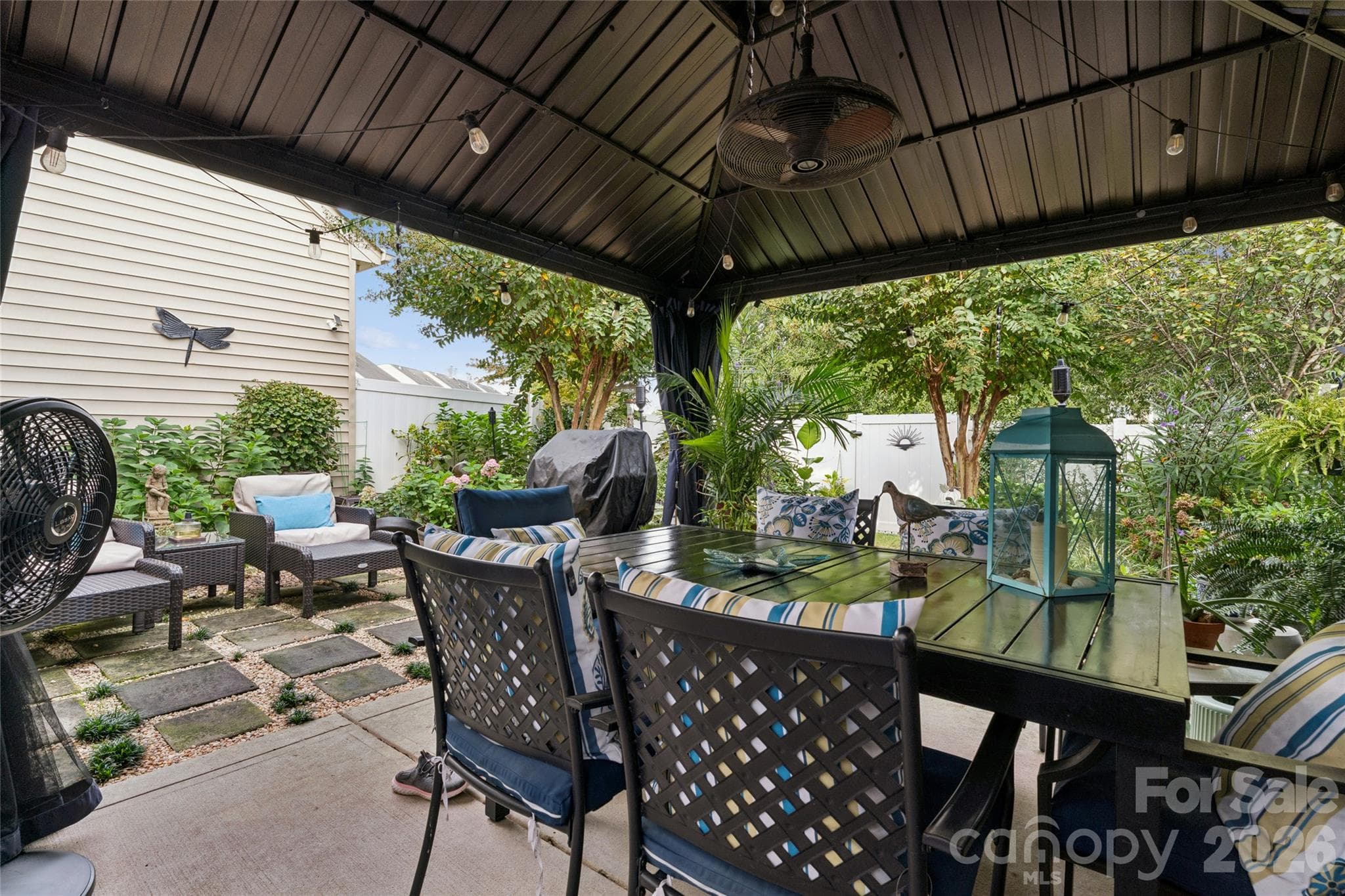 Private back yard view from under gazebo looking out at lush landscape and garden - 9506 Birkwood Court, Charlotte