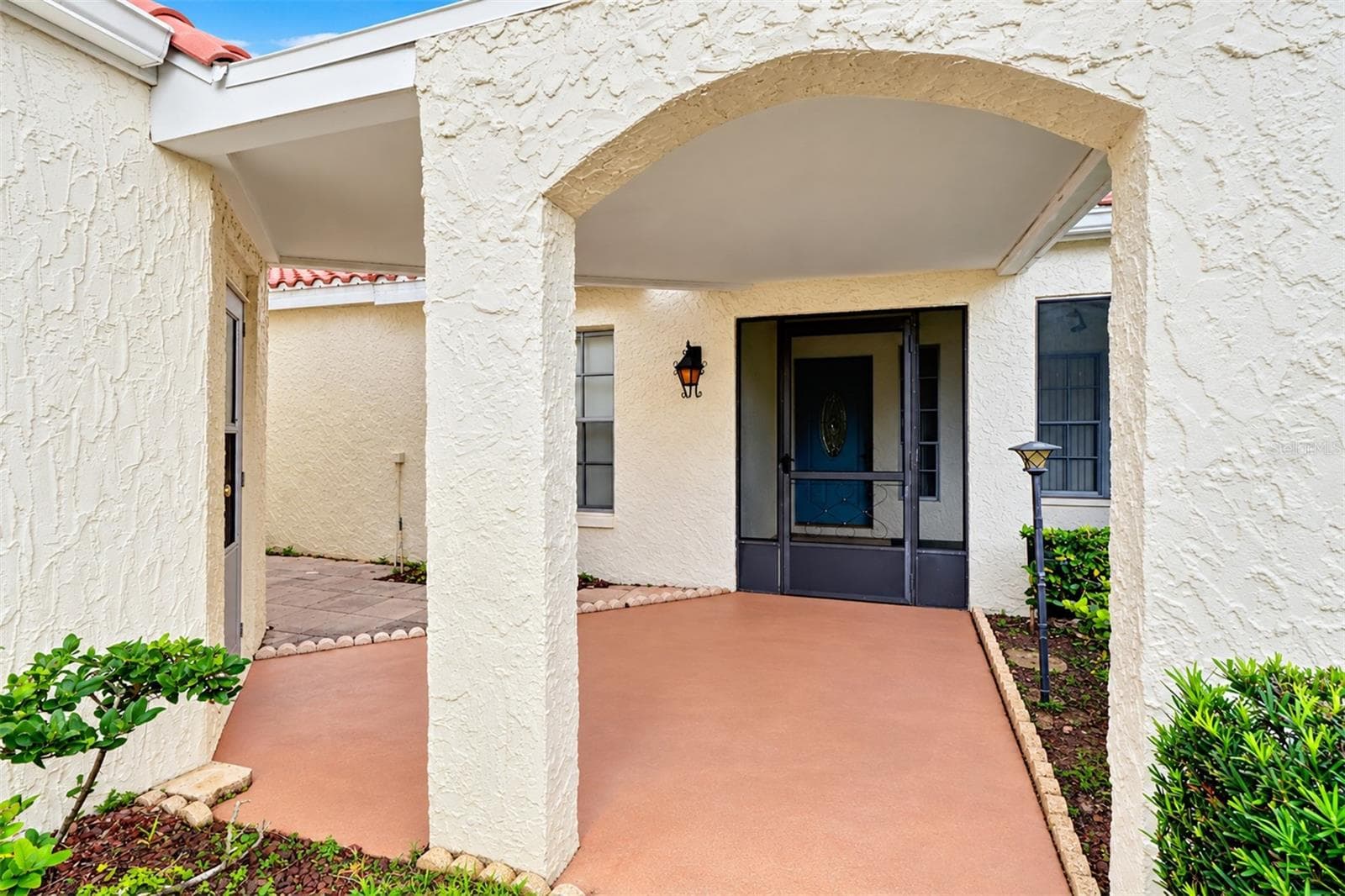 Covered breezeway area from garage and covered entry - 978 MADRID DR, PALM HARBOR