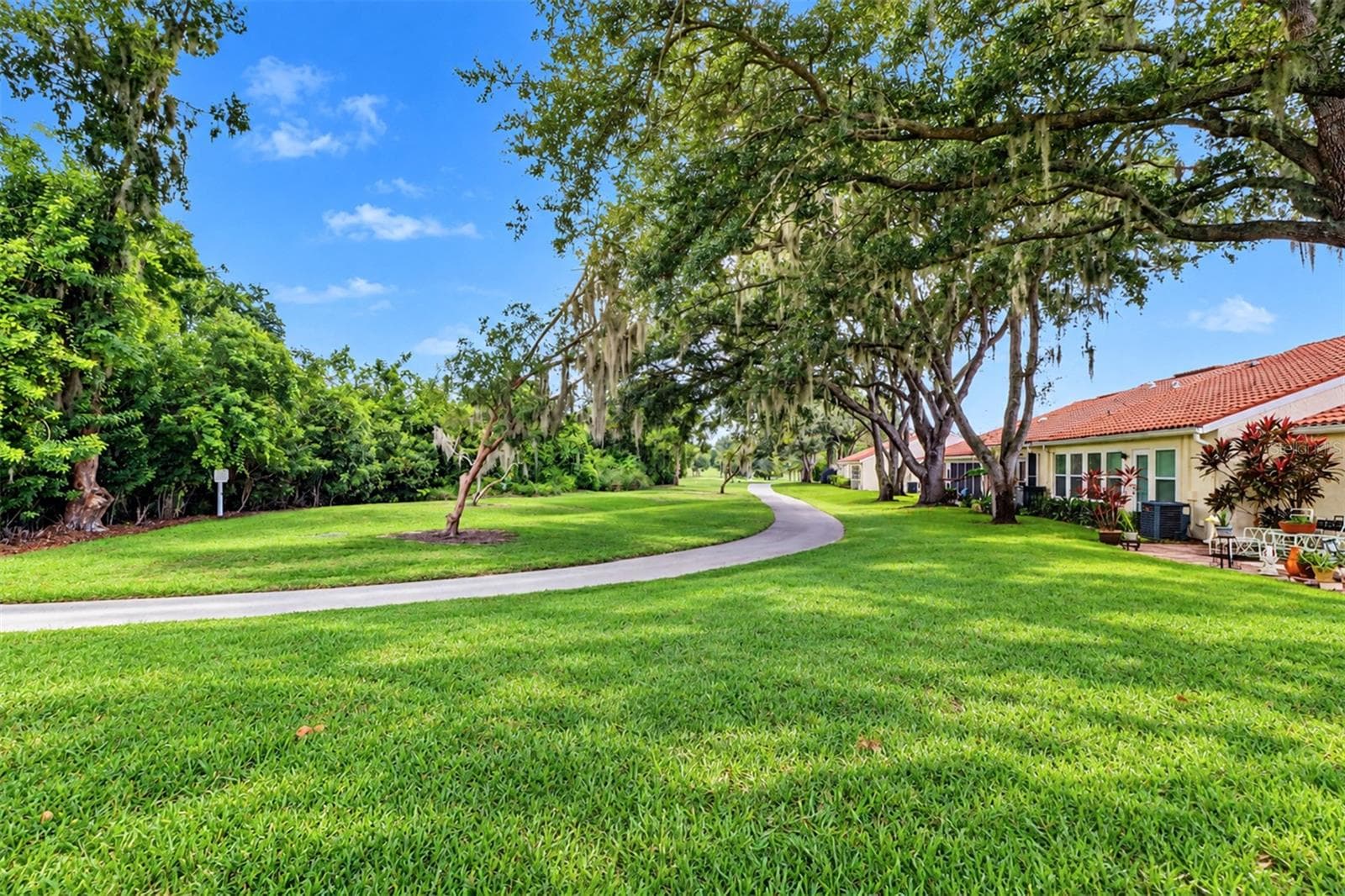 View from the kitchen down the fairway of the golf course - 978 MADRID DR, PALM HARBOR