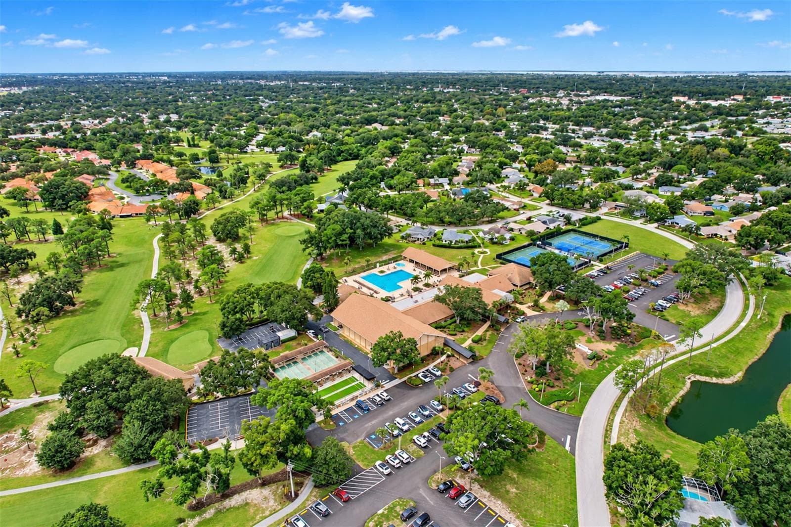 Aerial showing the massive Highland Lakes clubhouse and outside recreational facilities - 978 MADRID DR, PALM HARBOR