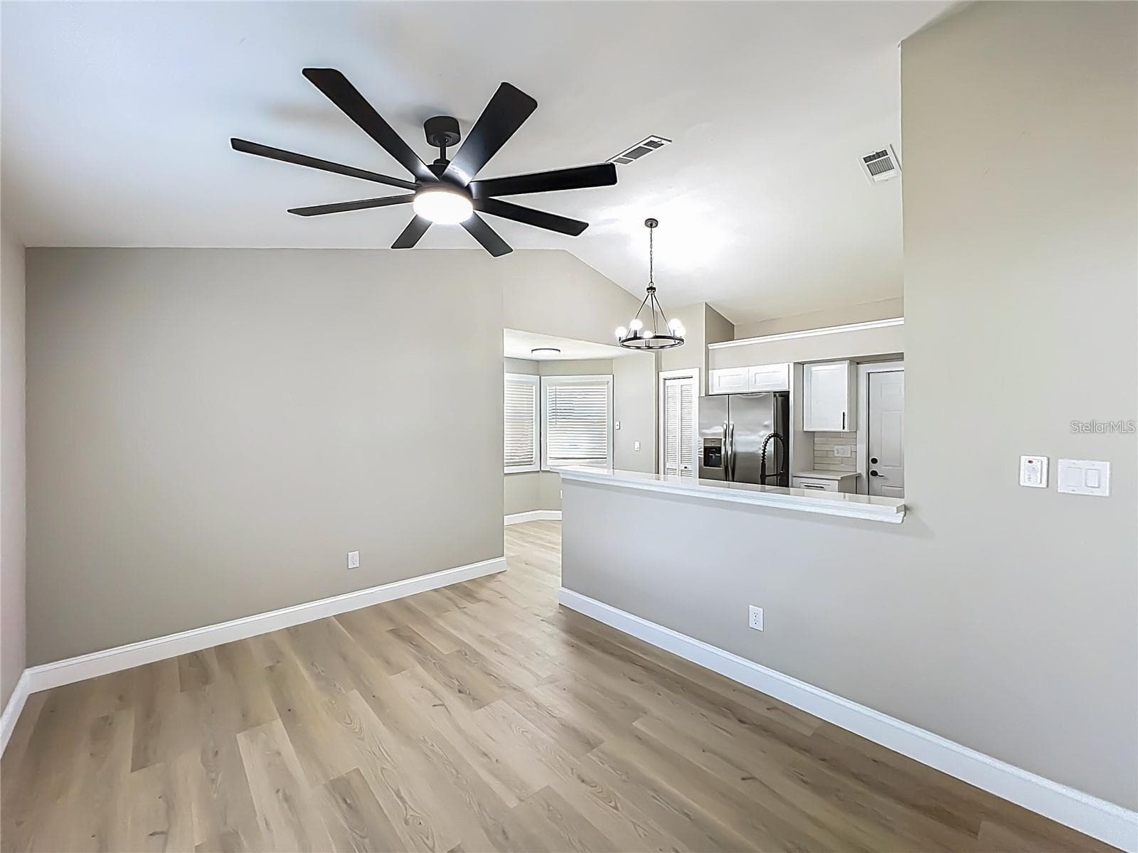 View from dining room area toward kitchen and dinette. - 6911 CRESCENT RIDGE RD, ORLANDO