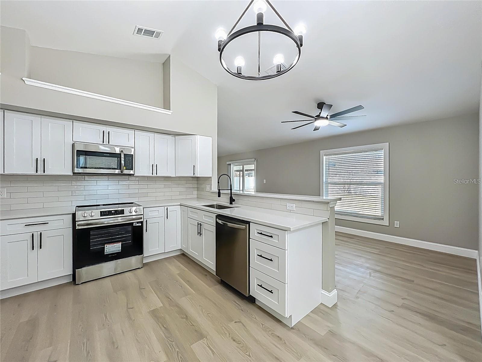 View from dinette area toward kitchen and dining room area. - 6911 CRESCENT RIDGE RD, ORLANDO