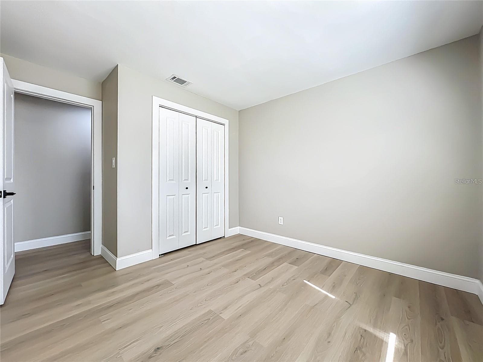 View of bedroom two toward entrance and closet. - 6911 CRESCENT RIDGE RD, ORLANDO
