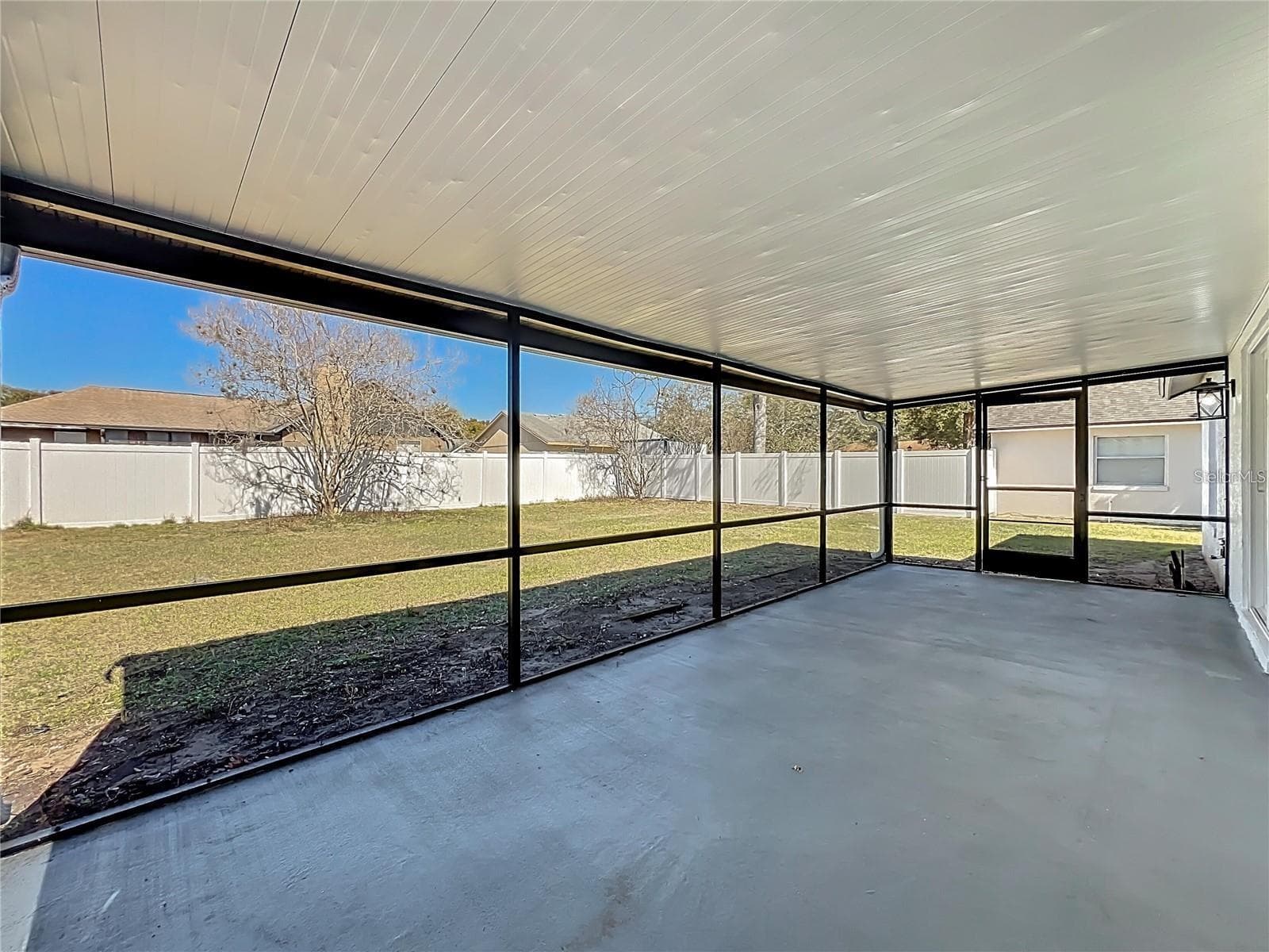 View of screened in patio and fenced backyard. - 6911 CRESCENT RIDGE RD, ORLANDO