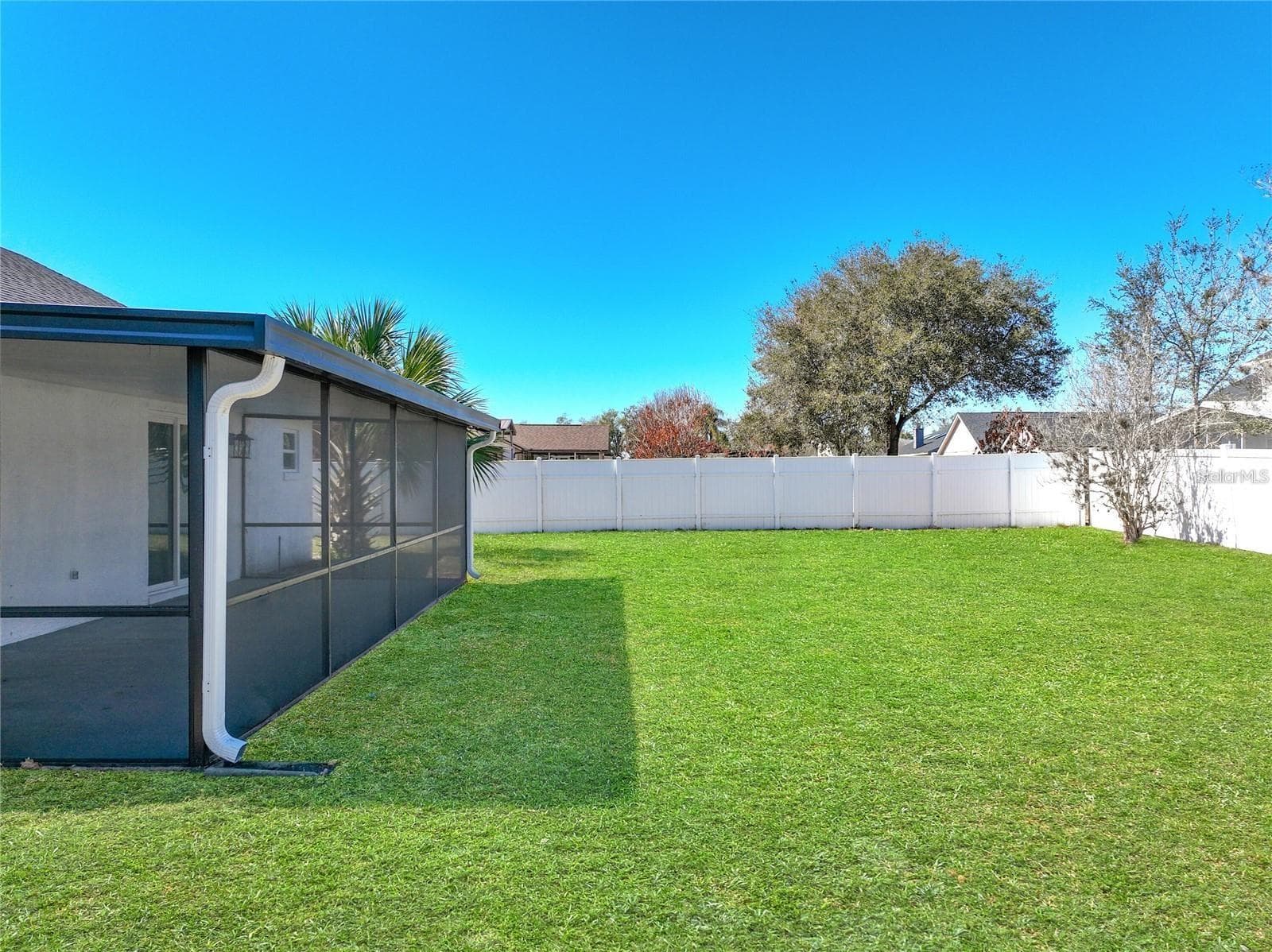 View of vinyl fencing, mature landscaping. - 6911 CRESCENT RIDGE RD, ORLANDO