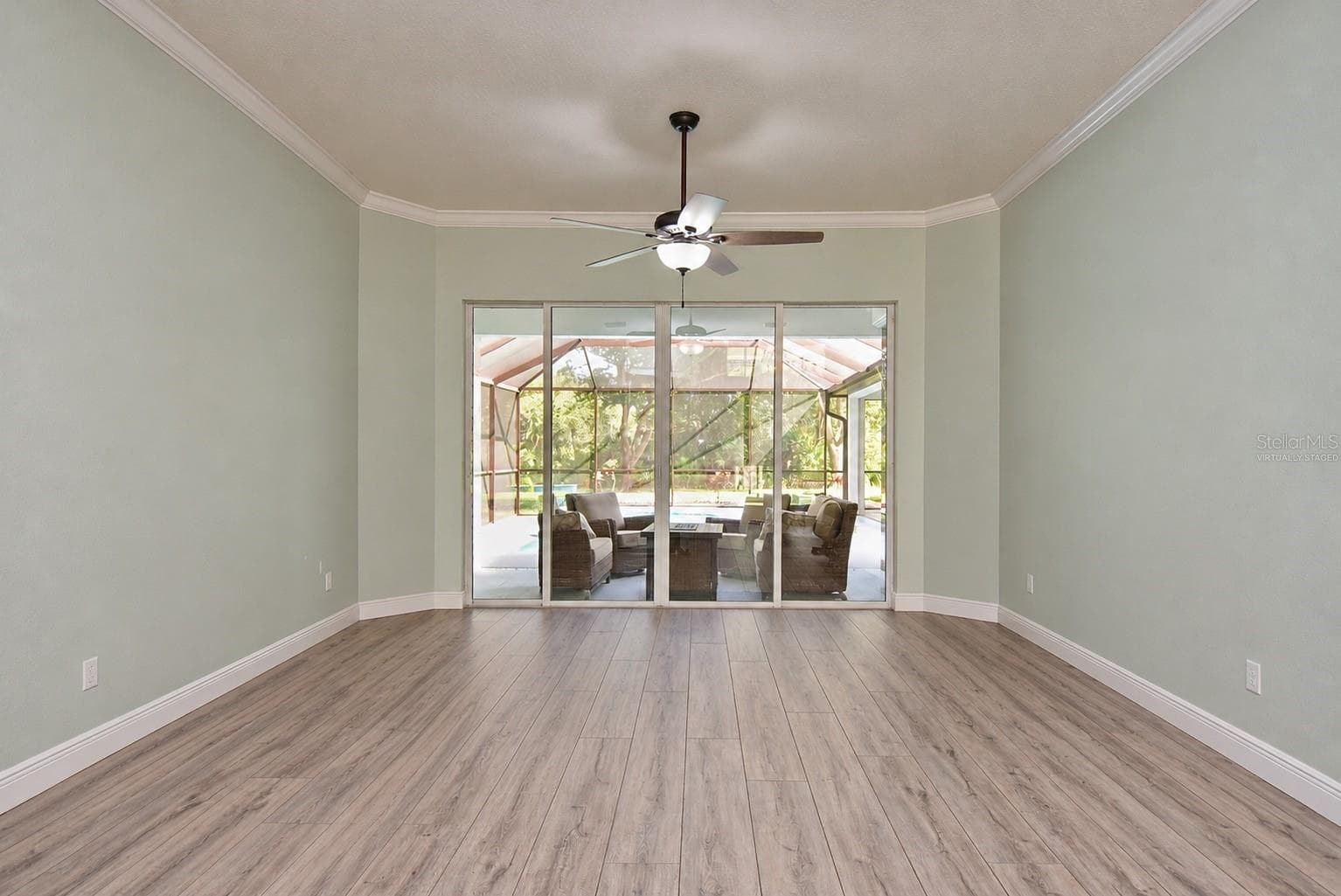 Front living room, virtually staged, gym equipment digitally removed - 8309 MISTY LAKE CIR, SARASOTA