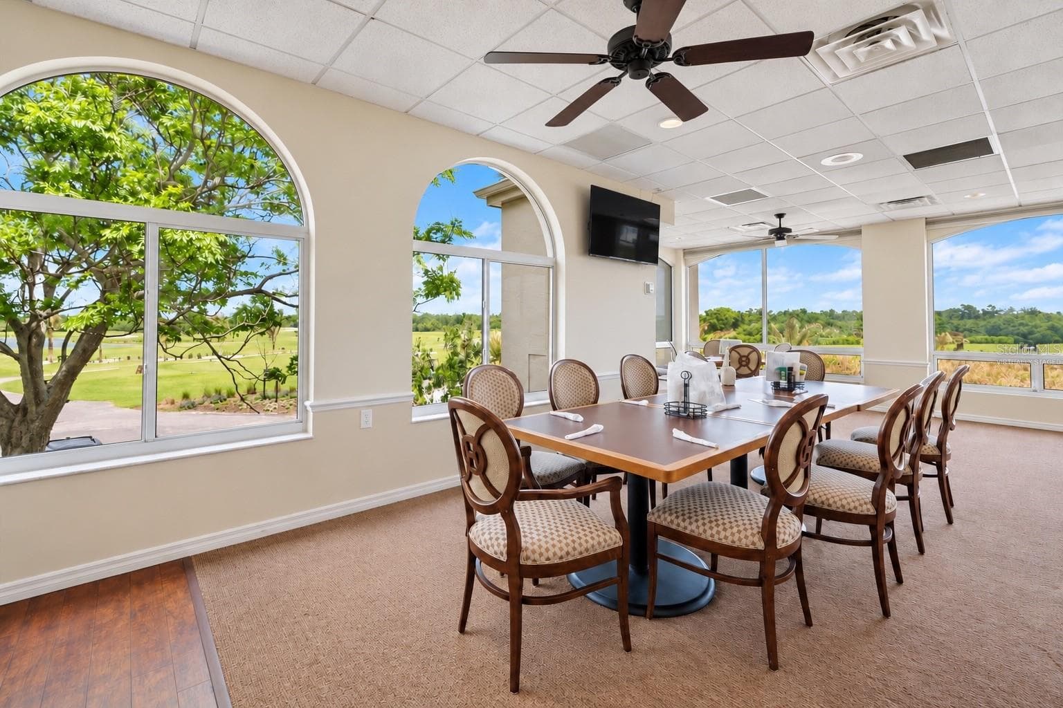 Clubhouse window dining room, virtually staged, condiments removed and TV darkened - 8309 MISTY LAKE CIR, SARASOTA