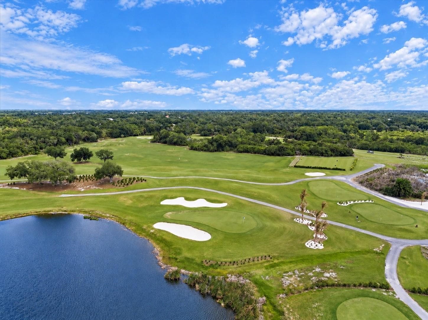 Community lake and golf course, virtually staged, selected golf carts removed - 8309 MISTY LAKE CIR, SARASOTA