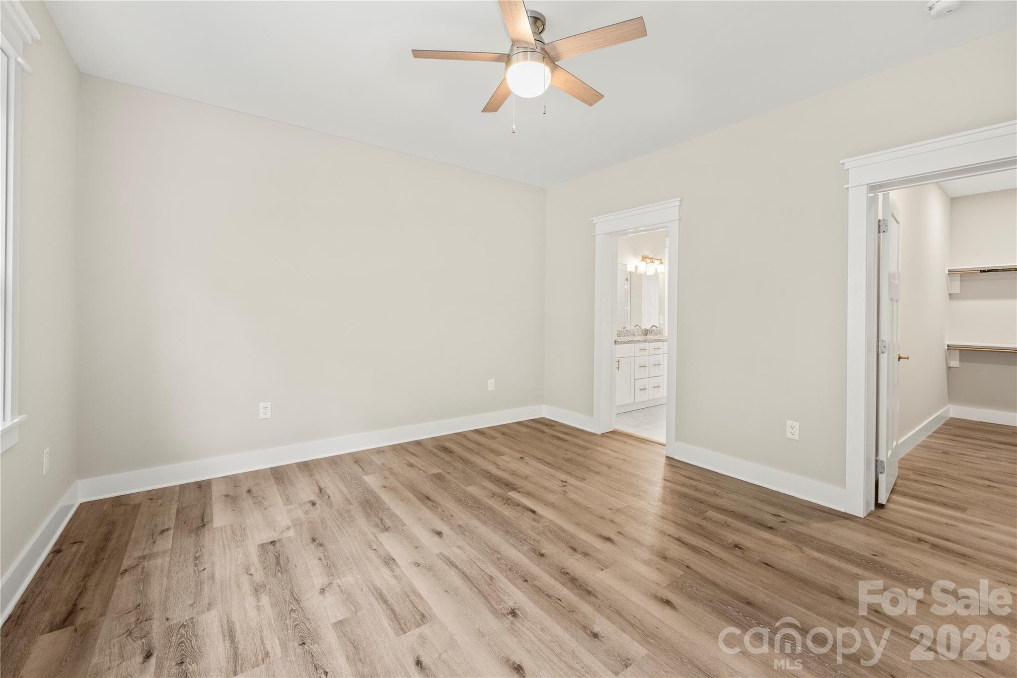 owner suite looking at walk in closet and primary bath - 9 Nellie Bell Lane, Swannanoa