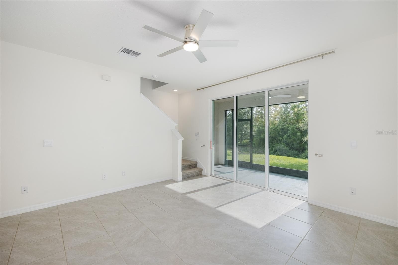 Living Room with Triple Sliders out to Lanai with Gorgeous View~ - 11166 CRESCENT DEER DR, LAND O LAKES