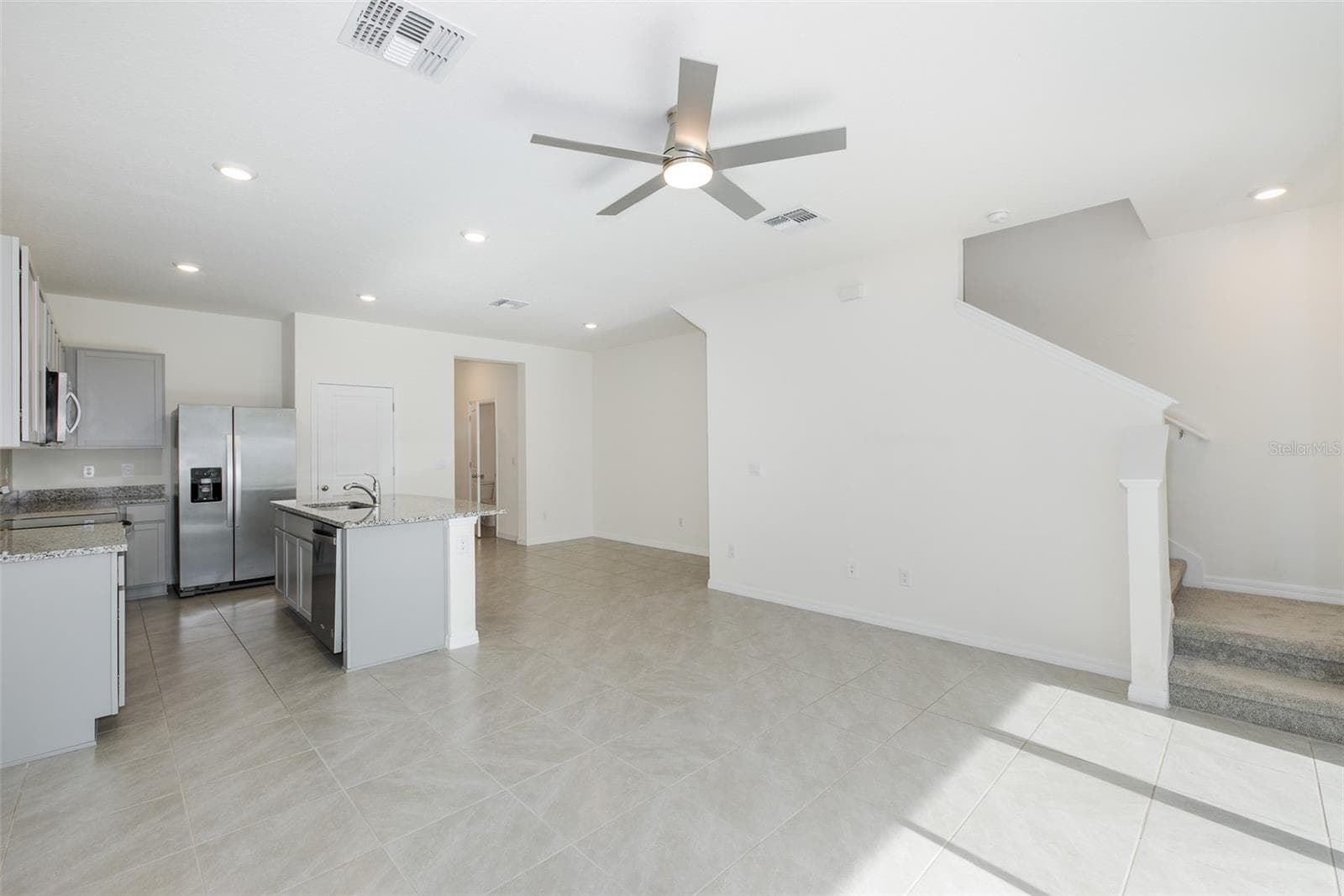 The open-concept design flows seamlessly into the living and dining areas—perfect for today's lifestyle. - 11166 CRESCENT DEER DR, LAND O LAKES