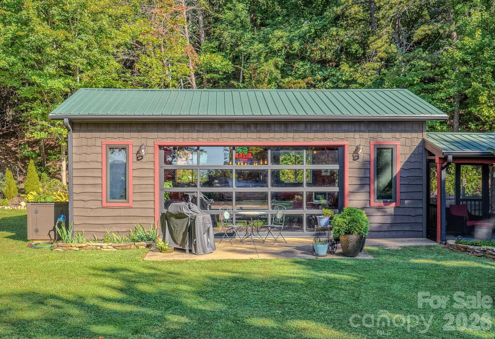 Recreation room with an insulated glass garage door that brings the outdoors in, perfect for entertaining year-round. - 54 Winning Way, Old Fort