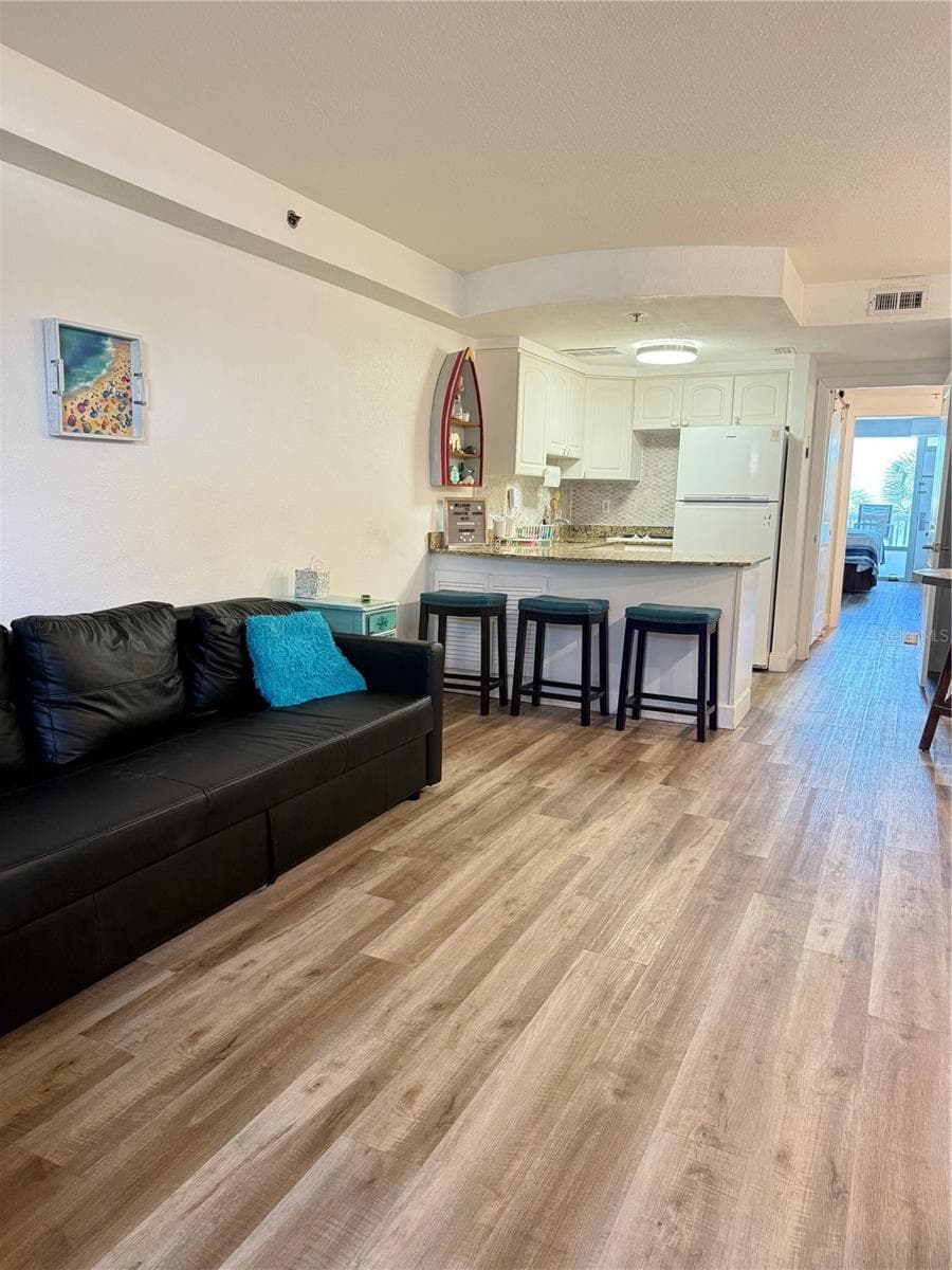 Living room with couch that makes a bed - 2700 N ATLANTIC AVE #214, DAYTONA BEACH