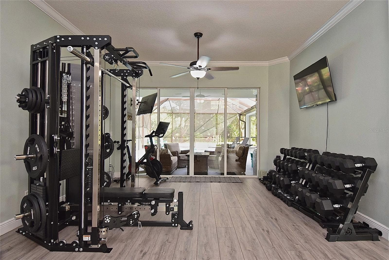 Front living space with gym equipment, original photo - 8309 MISTY LAKE CIR, SARASOTA