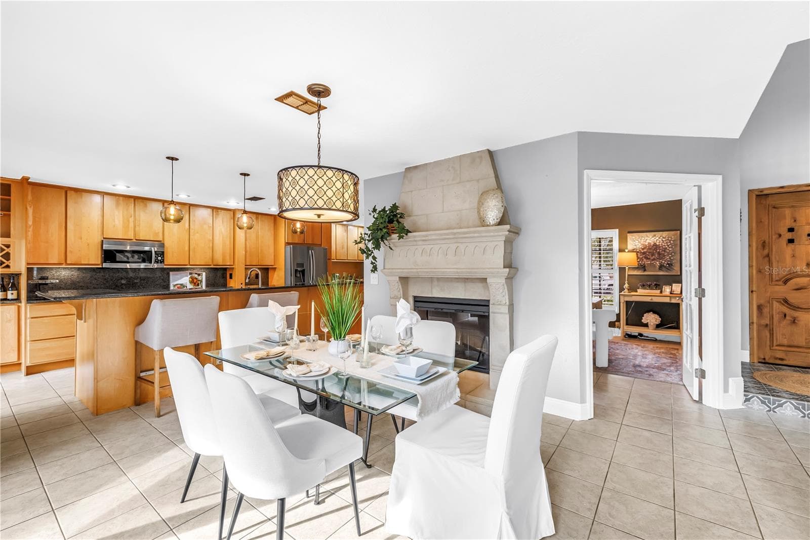 The stone fireplace is expertly crafted and features an electric fireplace insert. - 990 SAN CARLOS CT NE, ST PETERSBURG