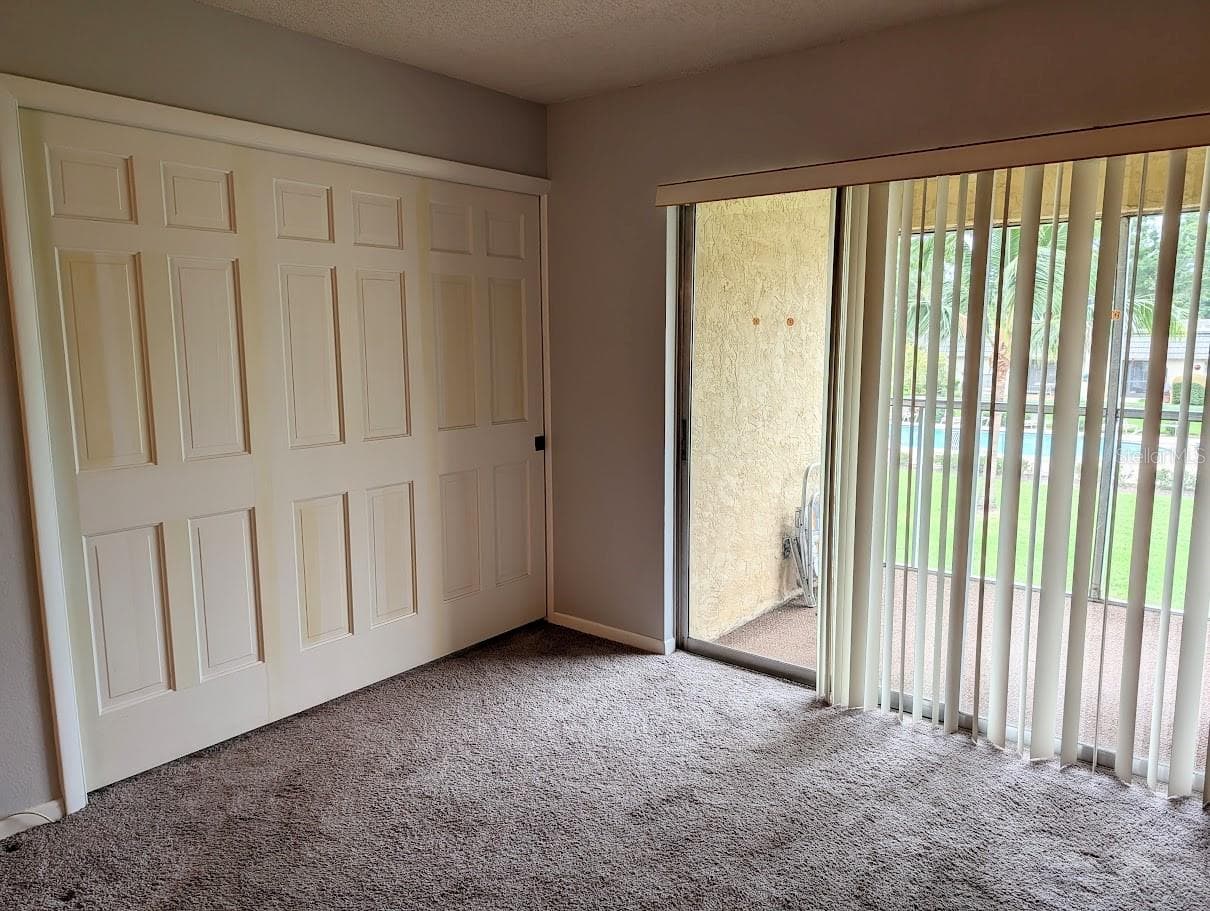 Entry to 2nd bedroom with pocket door fully closed - 8765 BARDMOOR BLVD #207, SEMINOLE