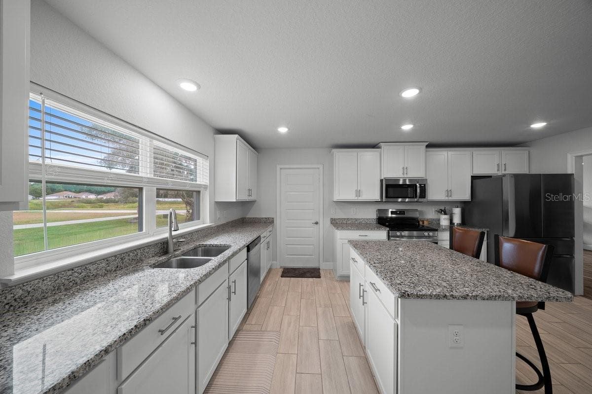 Kitchen and Garage door - 140 NW 113TH CIR, OCALA