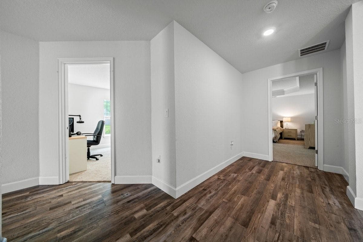 Looking at on suite and first bedroom from hallway - 140 NW 113TH CIR, OCALA