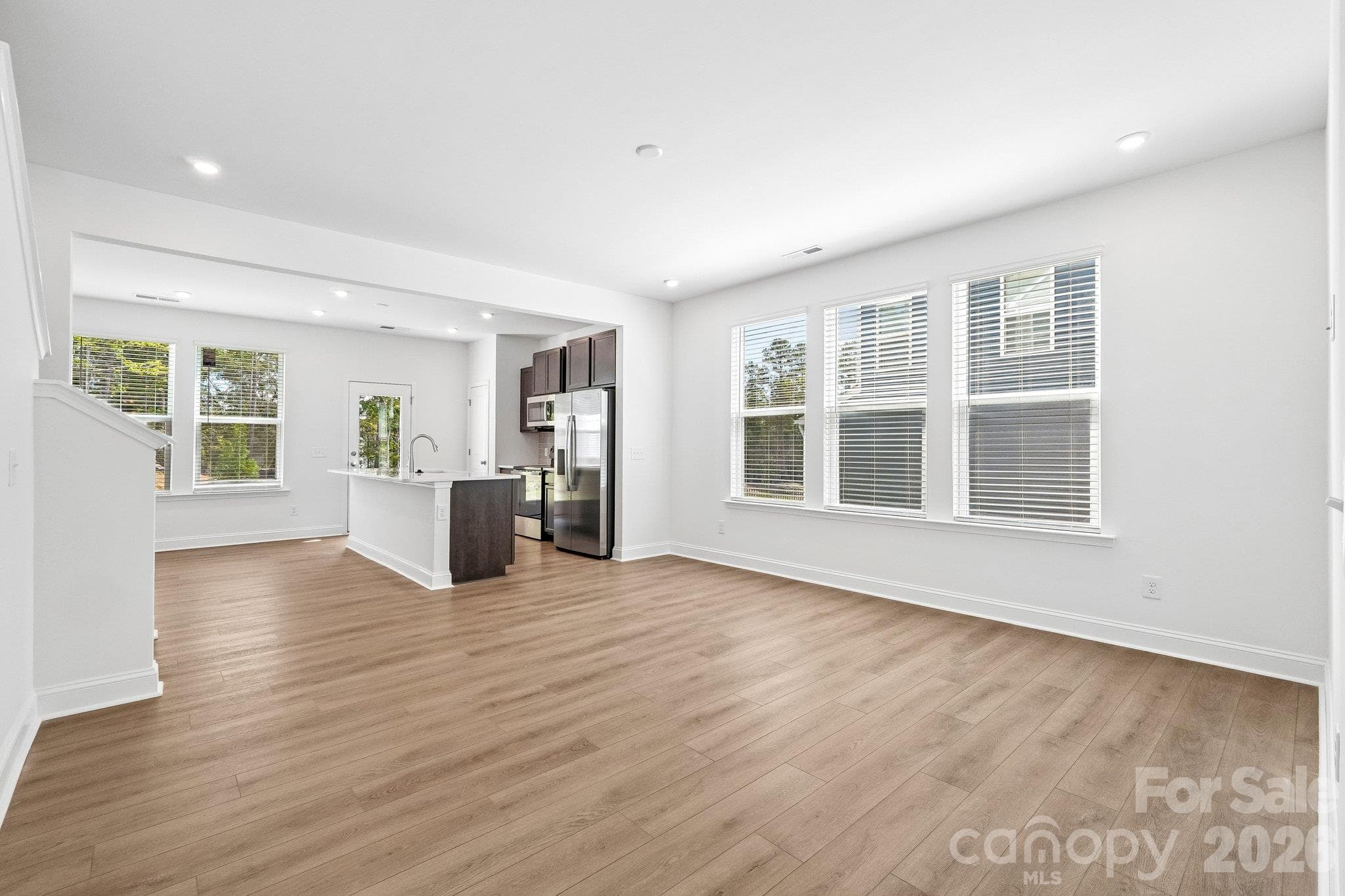 Open living area connects seamlessly to the kitchen for easy entertaining. - Bell Glen, Charlotte