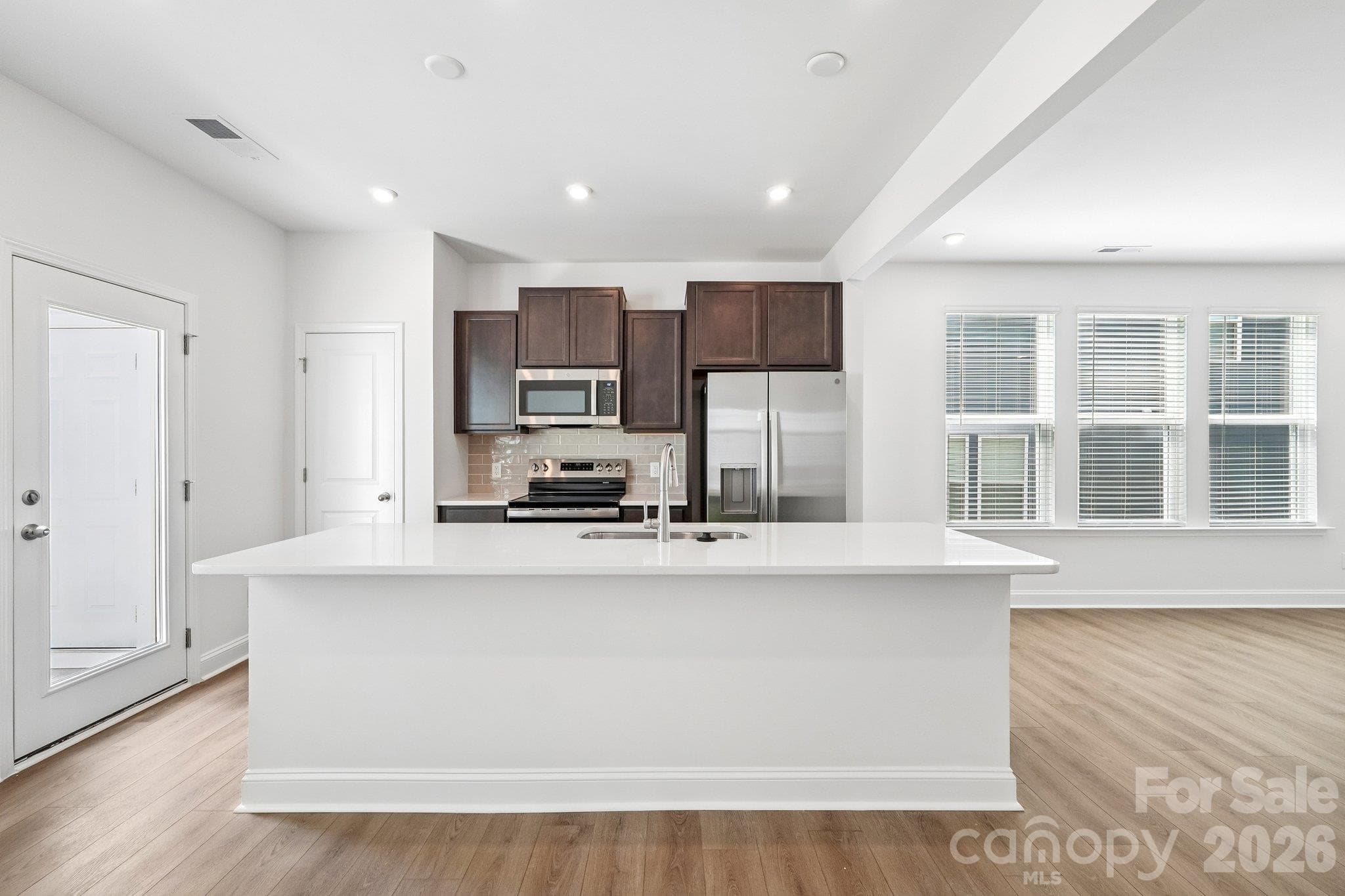 Expansive kitchen island brings cooking and conversation together. - Bell Glen, Charlotte