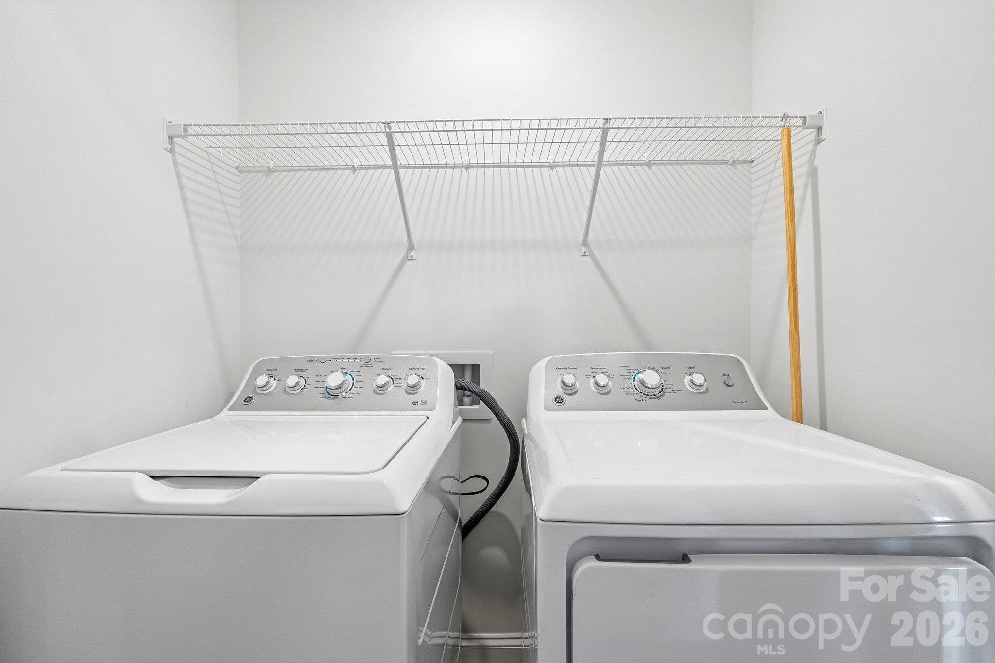 Convenient laundry space with washer, dryer, and overhead shelving. - Bell Glen, Charlotte