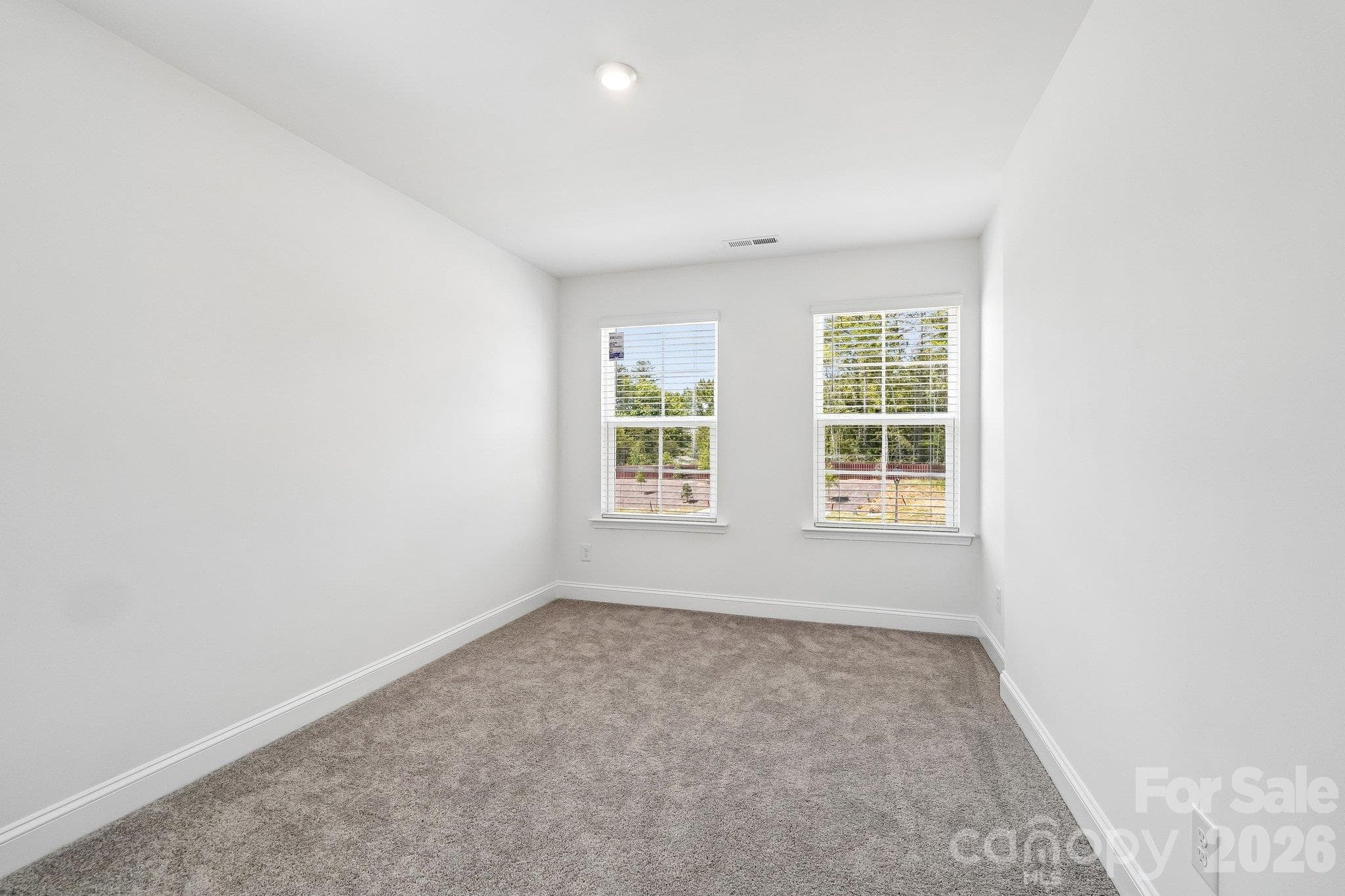 Bright bedroom offers comfortable space to relax and recharge. - Bell Glen, Charlotte