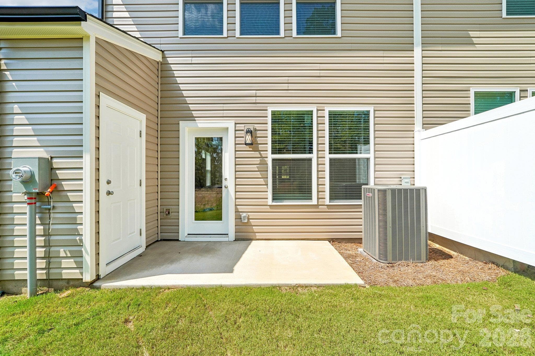 Backyard patio creates an inviting spot for outdoor seating. - Bell Glen, Charlotte
