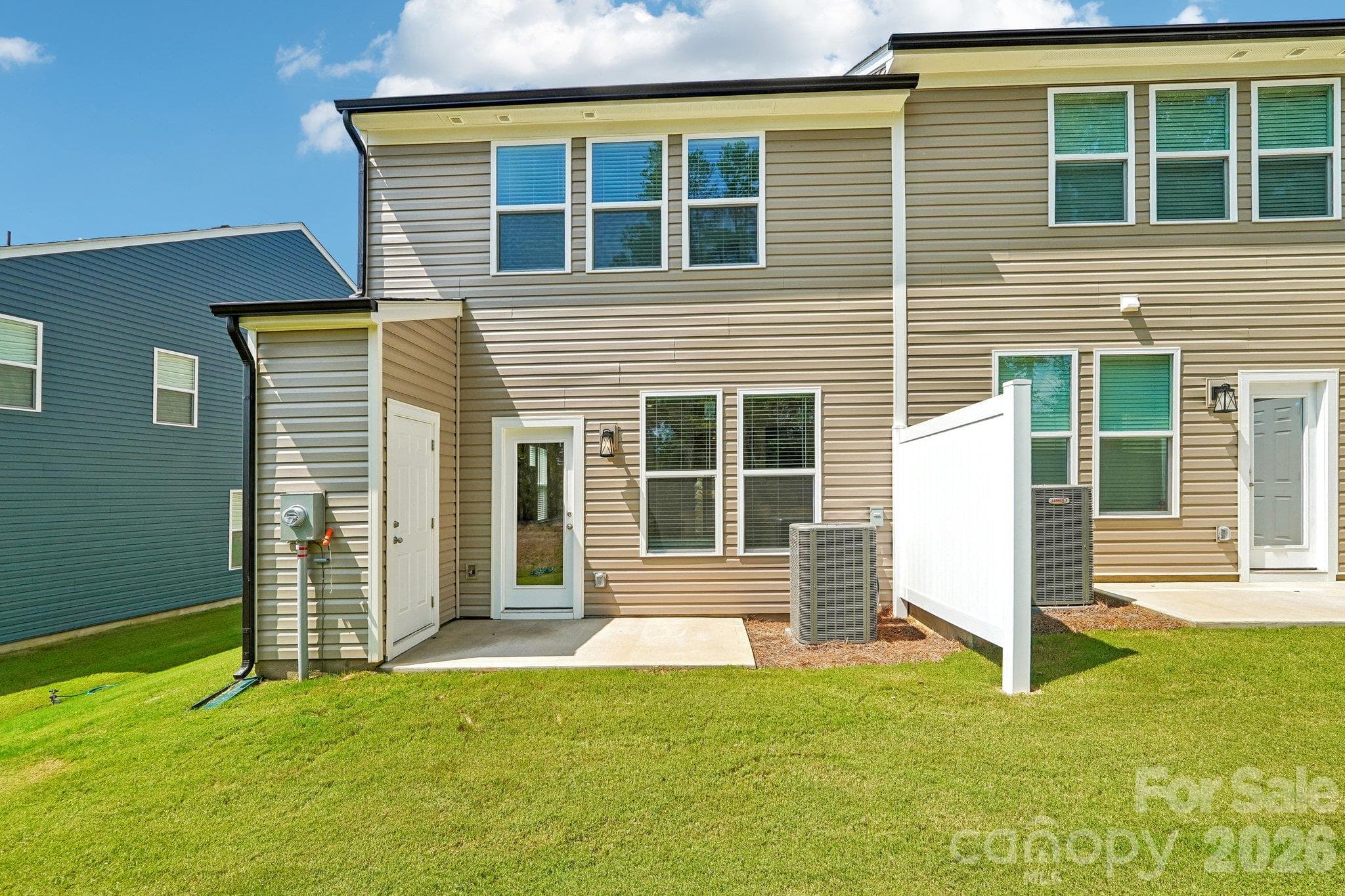 Rear exterior showcases the lawn and patio space. - Bell Glen, Charlotte