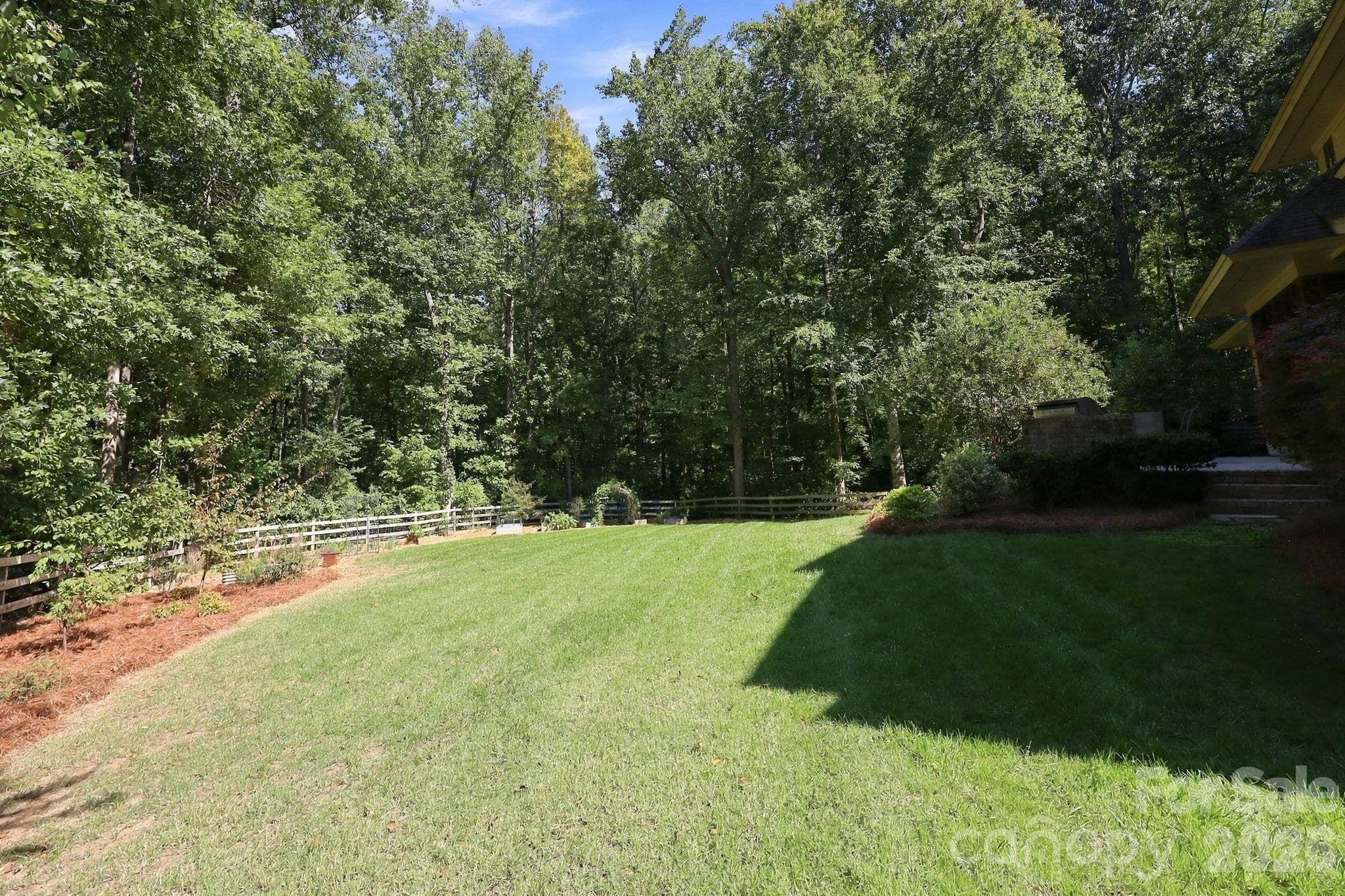 Fenced yard with gardens - property extends well beyond fence line. Plenty of room for a pool. - 115 Saddle Creek Court, Davidson