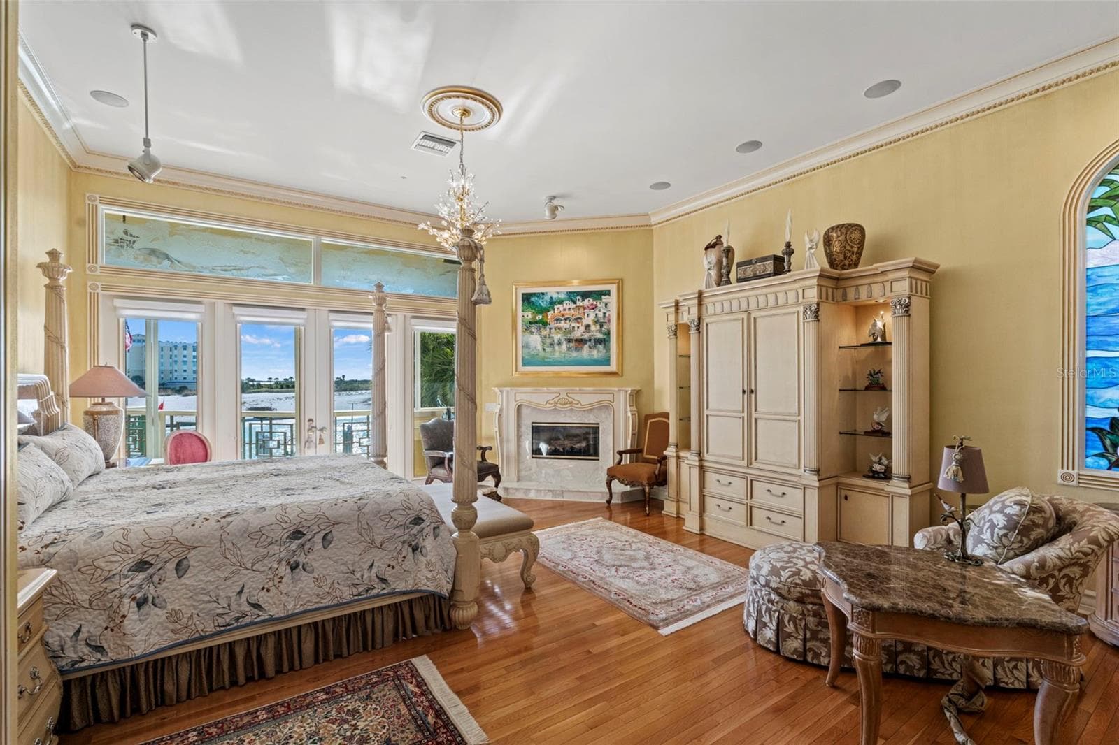 Primary Suite with Harwood Floors, Fireplace, Crown Molding and French Doors to the Balcony - 964 MONTE CRISTO BLVD, TIERRA VERDE