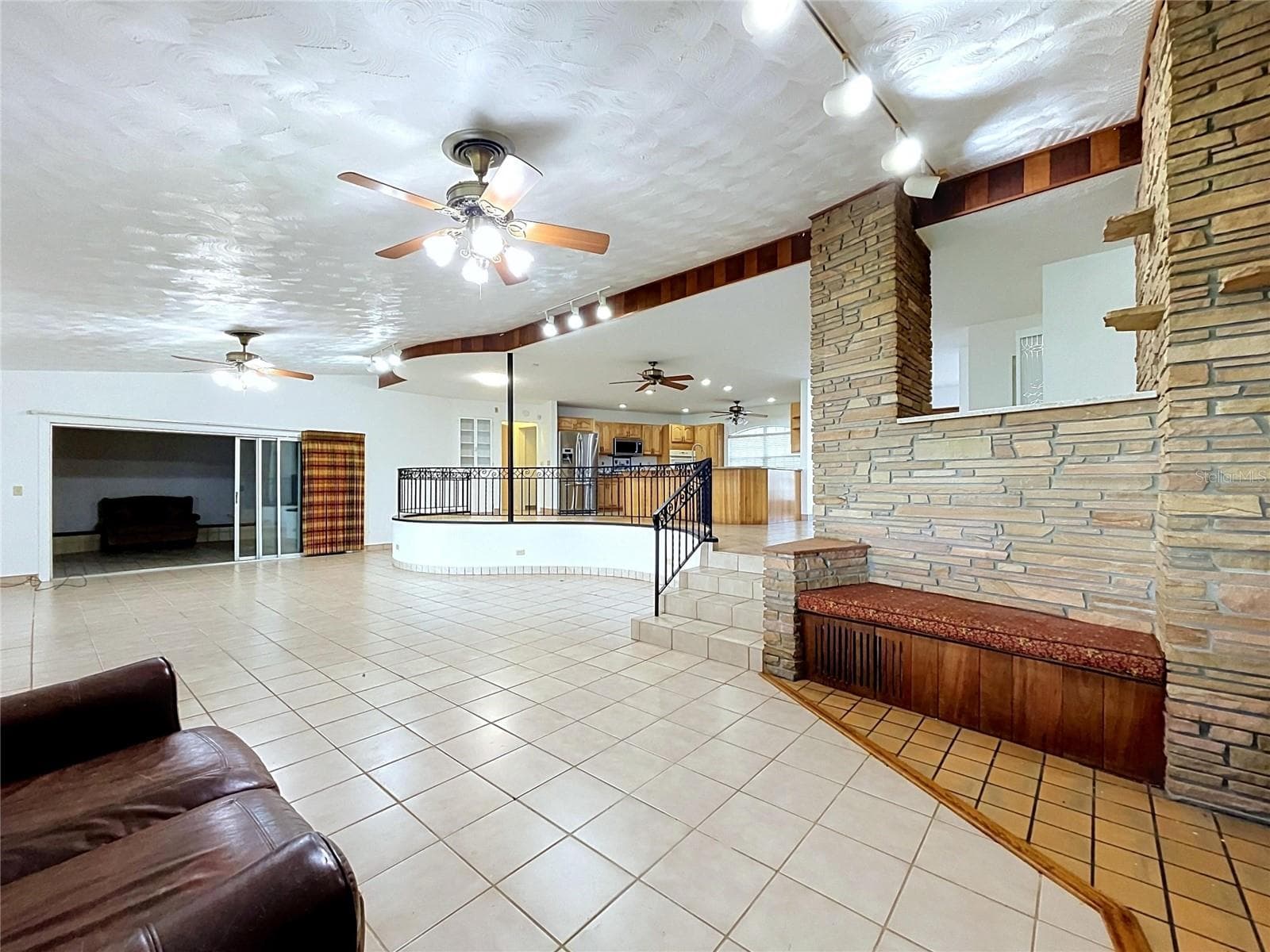 Living area with tile flooring and kitchen access - 1348 EDGEWATER BEACH DR, LAKELAND