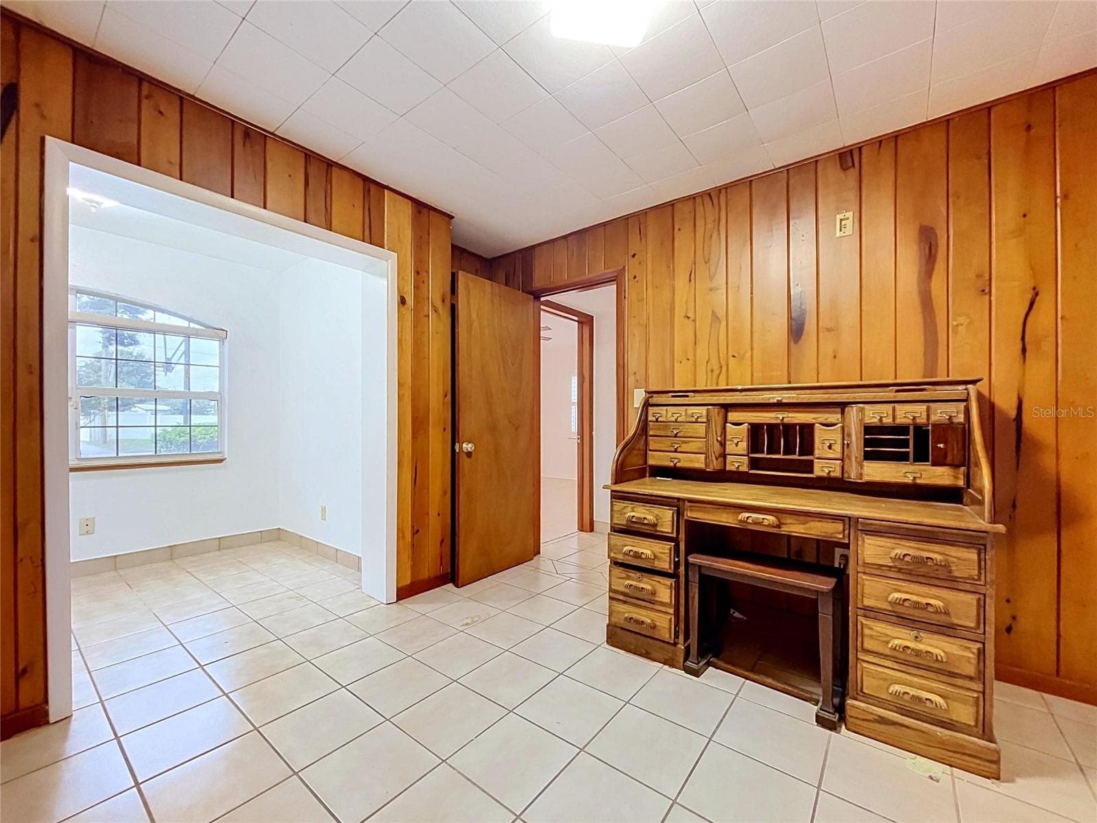 Bedroom 3 with wood-paneled walls (desk - personal property not included) - 1348 EDGEWATER BEACH DR, LAKELAND