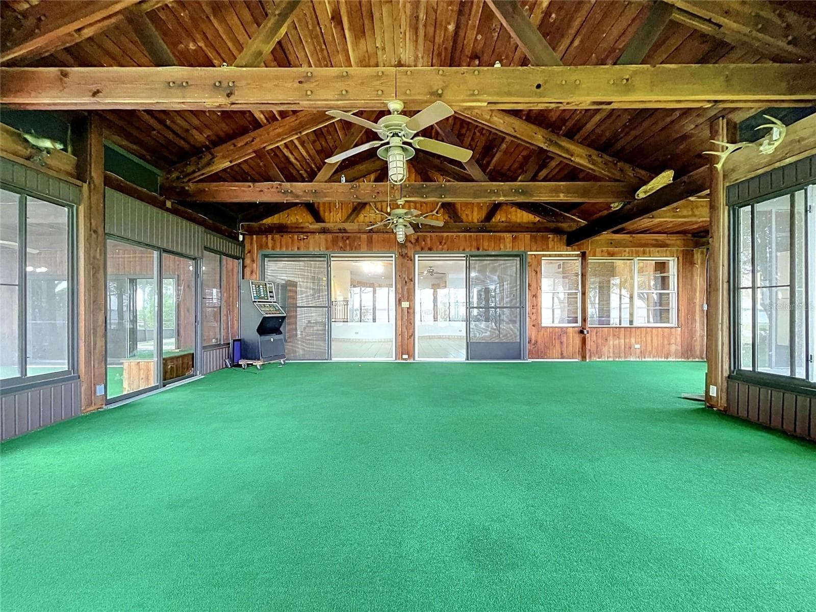 Lanai with large windows and vaulted wood ceiling - 1348 EDGEWATER BEACH DR, LAKELAND