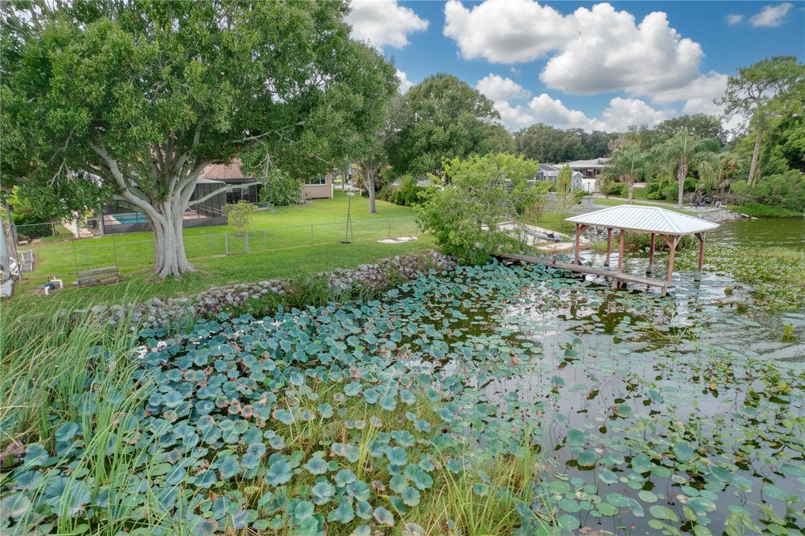 Aerial view from water of backyard, dock, and ramp - 1348 EDGEWATER BEACH DR, LAKELAND