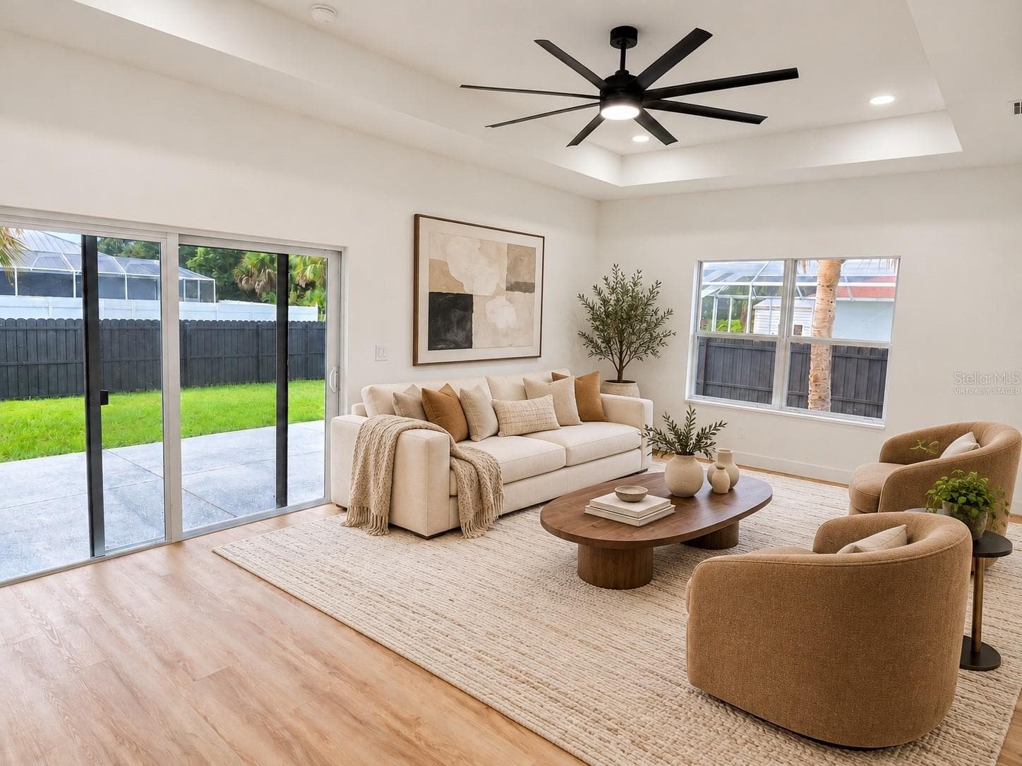Virtually staged living room with sliding glass doors leading to the backyard. - 3126 BELLEVILLE TER, NORTH PORT